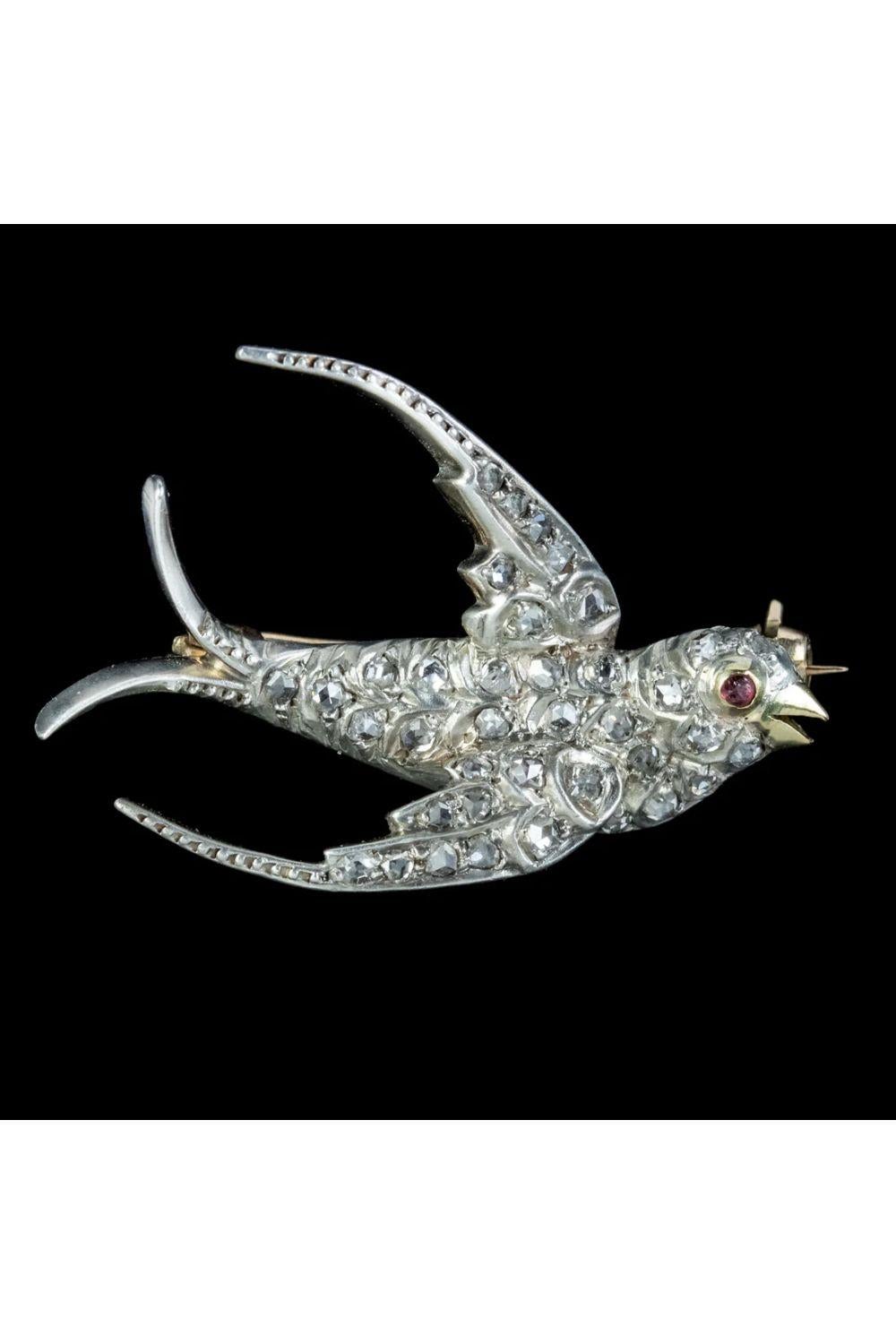 A pretty antique Victorian swallow brooch from the late 19th Century decorated with glistening rose cut diamonds and a red paste eye.

The image of a swallow was popular during the Victorian era and was often gifted as a romantic token as the birds