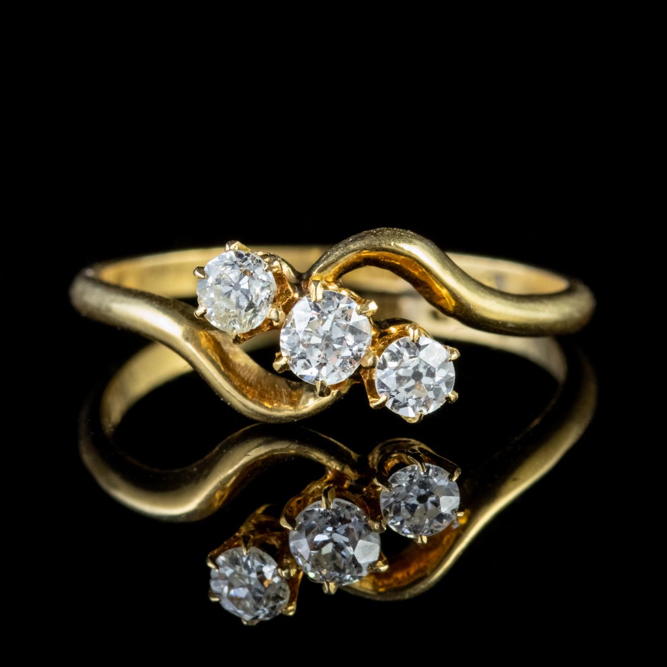 This glorious Victorian Diamond trilogy twist ring is crafted around three beautiful European old cut Diamonds. The 18ct Yellow Gold shank has been formed into two elegant curves which arc into the central gallery. 

The Old Cut Diamonds sparkle