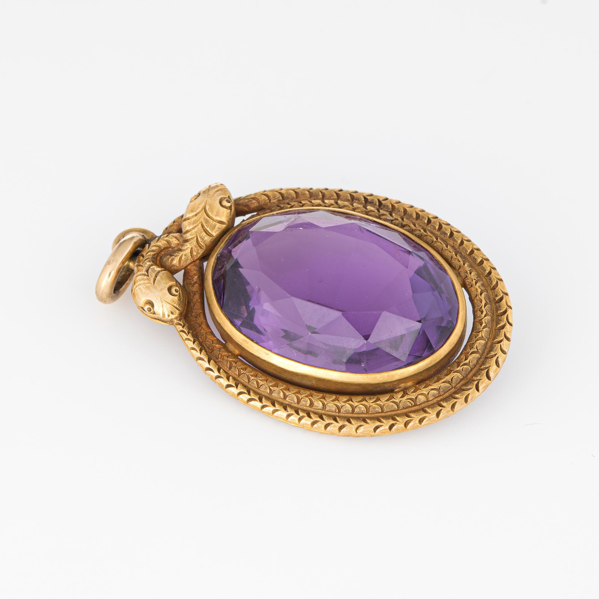 Finely detailed antique Victorian double snake pendant (circa 1880s to 1900s) crafted in 18k yellow gold. 

Oval faceted amethyst measures 23mm x 16mm (estimated at 25 carats). The amethyst is in excellent condition and free of cracks or chips.