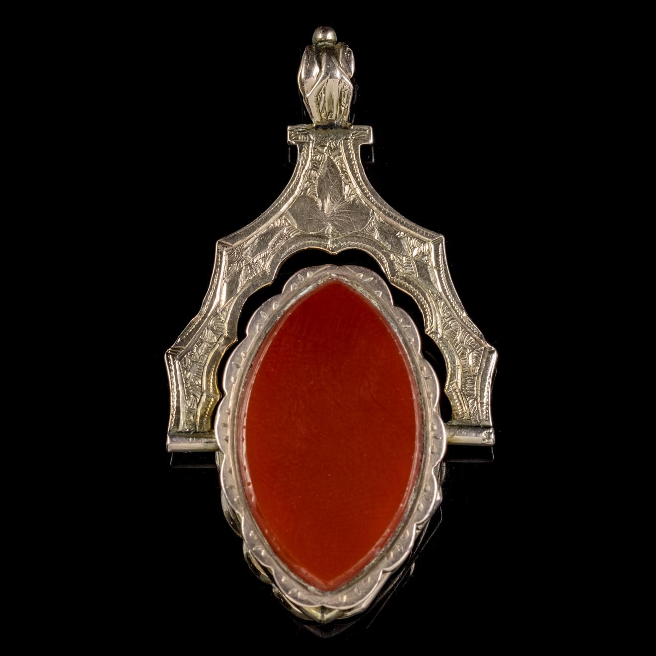 An extraordinary antique 9ct Gold double sided swivel locket from the Victorian era, Circa 1880.

The double sided locket is set with a natural green Jasper stone on the front and a deep orange Carnelian on the reverse. 

Carnelian has been worn