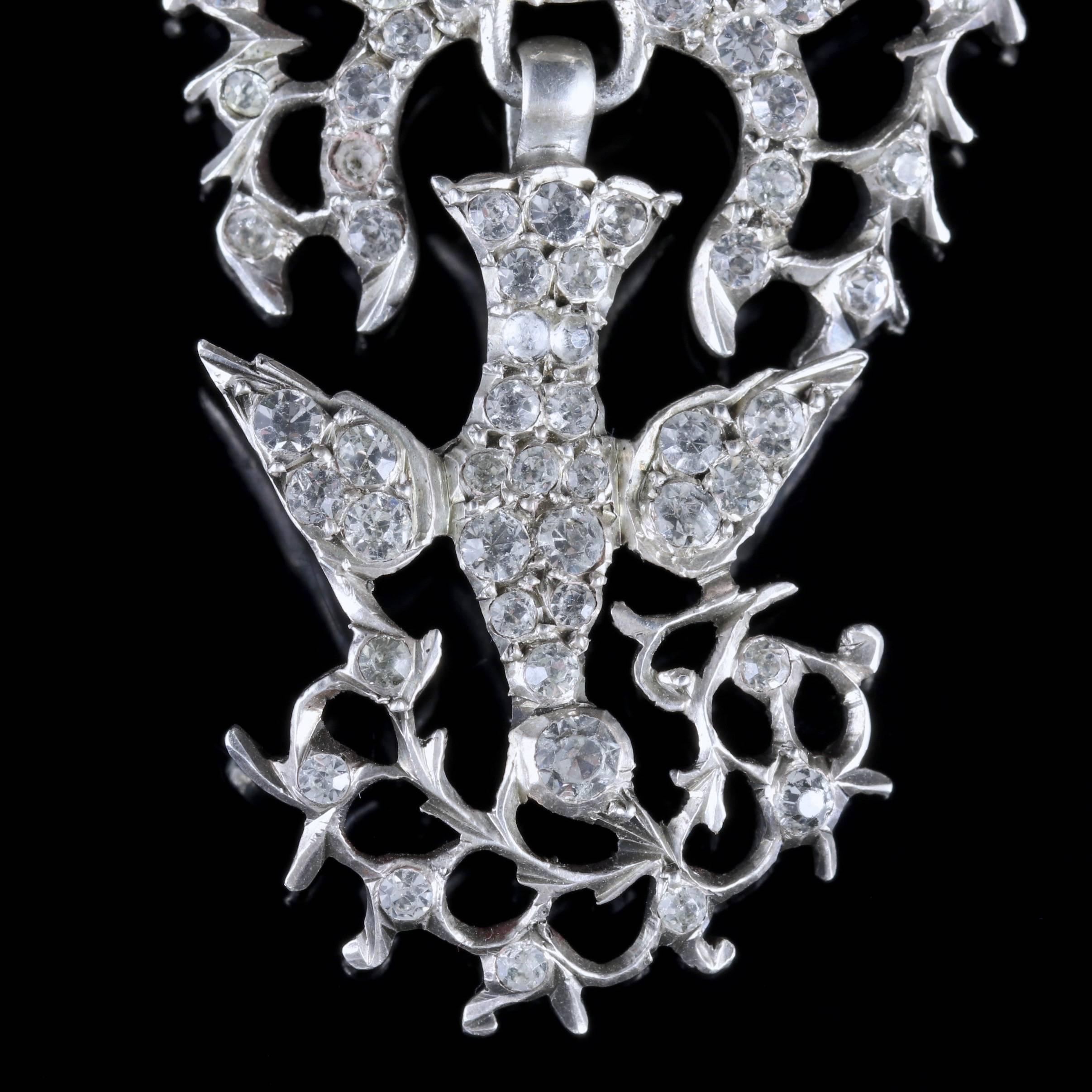 To read more please click continue reading below-

This beautiful antique Silver Paste Dove pendant is Victorian Circa 1860. 

The wonderful pendant is decorated in sparkling white Paste Stones and features a fancy bow with a hanging Dove carrying