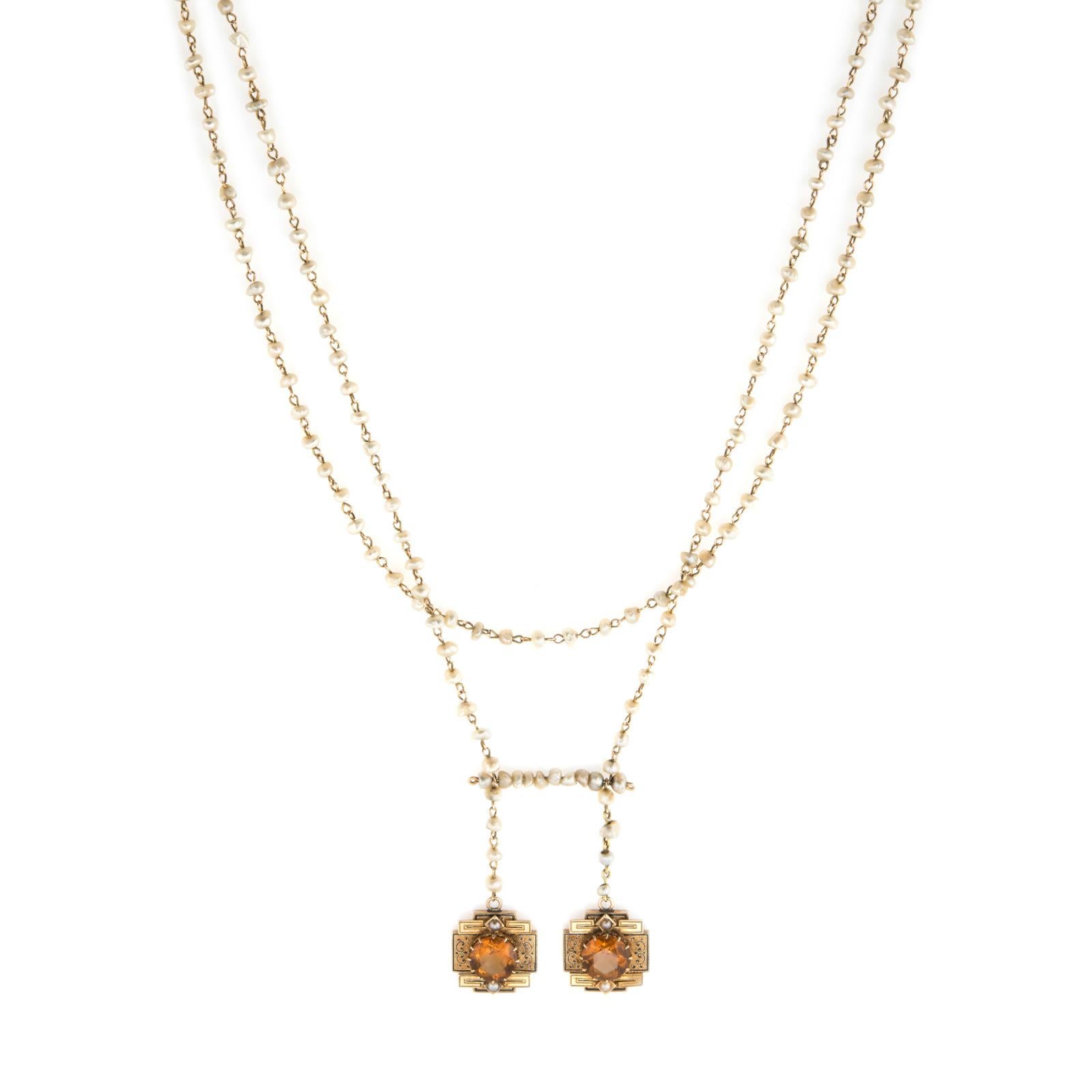 Elegant and finely detailed antique necklace (circa 1880s to 1900s), crafted in 14 karat yellow gold.  

Two faceted round cut citrines each measure 10mm (estimated at 3.50 carats each - 7 carats total estimated weight). The natural freeform seed