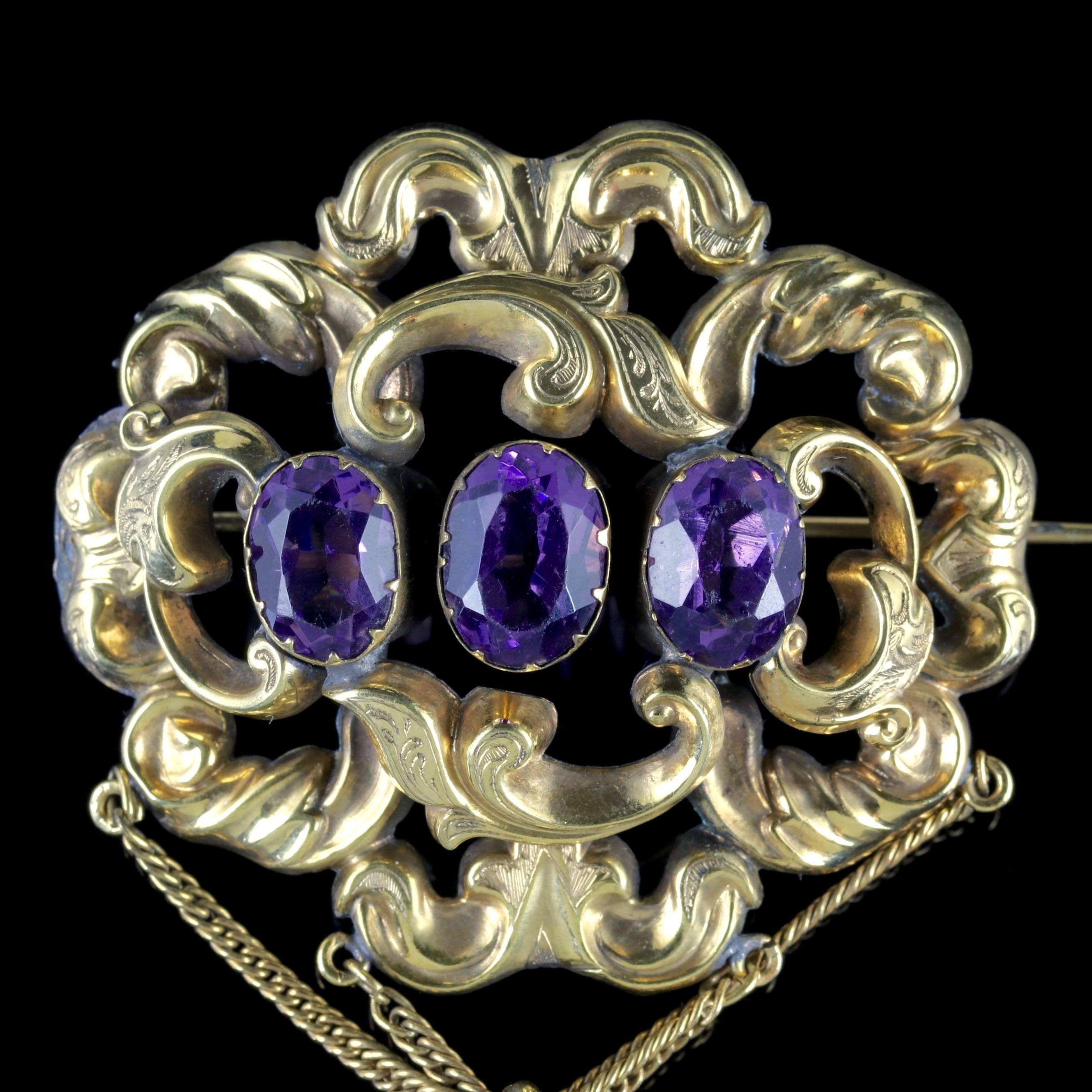 This magnificent antique Paste Stone dropper brooch is Victorian Circa 1900. 

The grand piece boasts decorative engraved workmanship with three purple Paste Stones running across the central gallery. 

Paste is a heavy, transparent flint glass that
