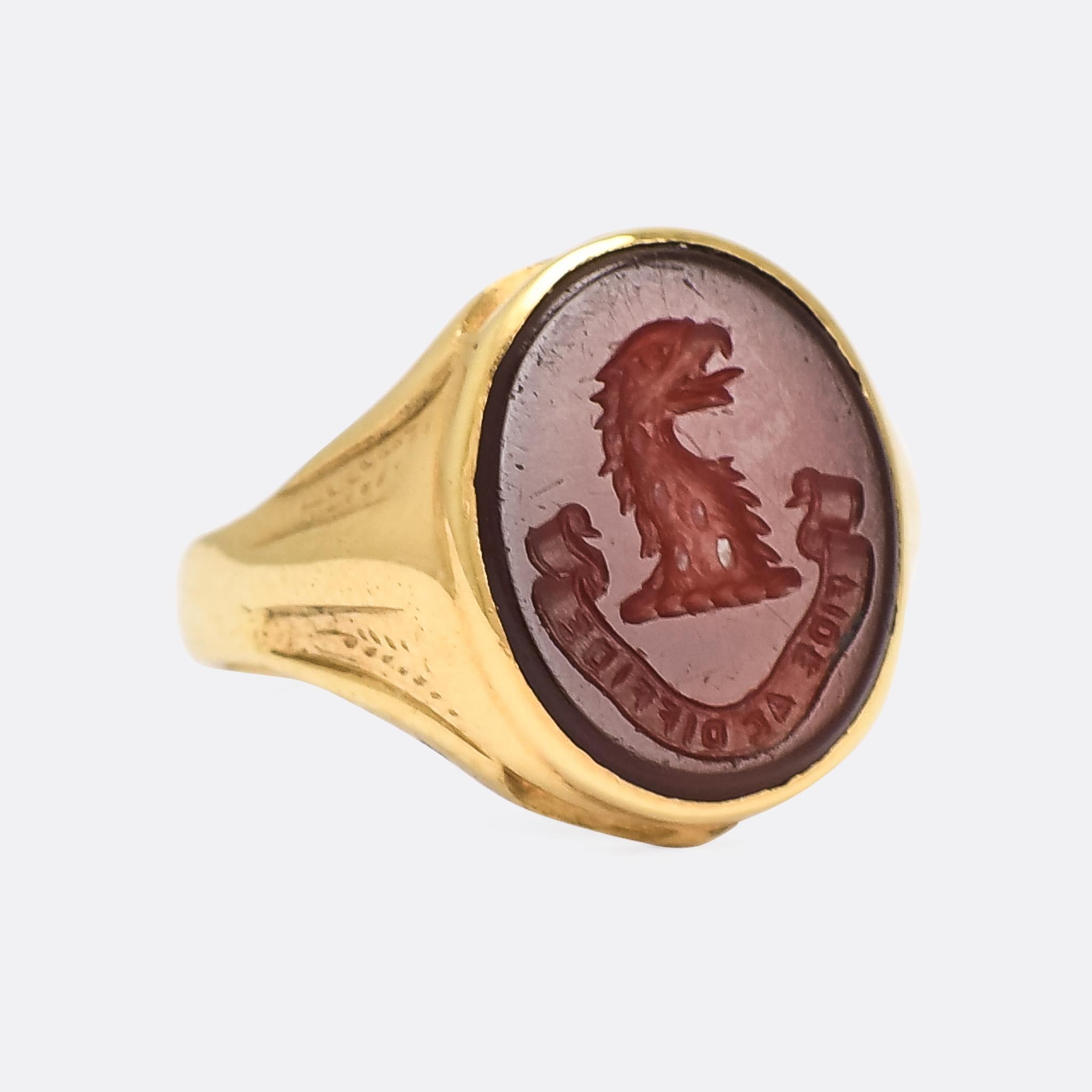 A superb Victorian carnelian signet ring with heraldic intaglio crest and motto. The crest depicts an eagle's head, above a banner with the Latin FIDE AC DIFFIDE, or 