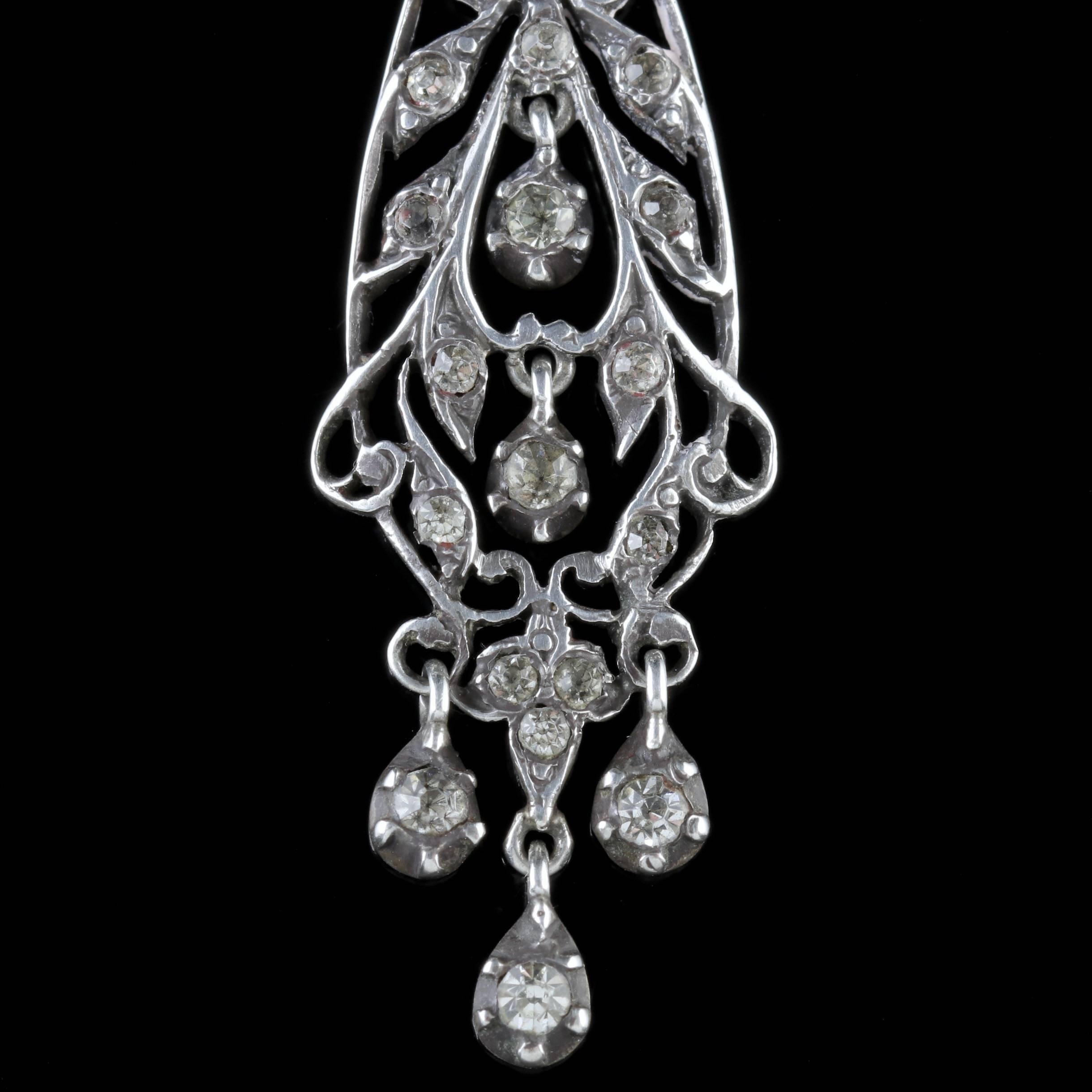 To read more please click continue reading below-

These stunning antique Silver Chandelier drop earrings are Victorian, Circa 1900. 

The fabulous pair are decorated in sparkling white Paste Stones with five lovely Paste droppers hanging below. 