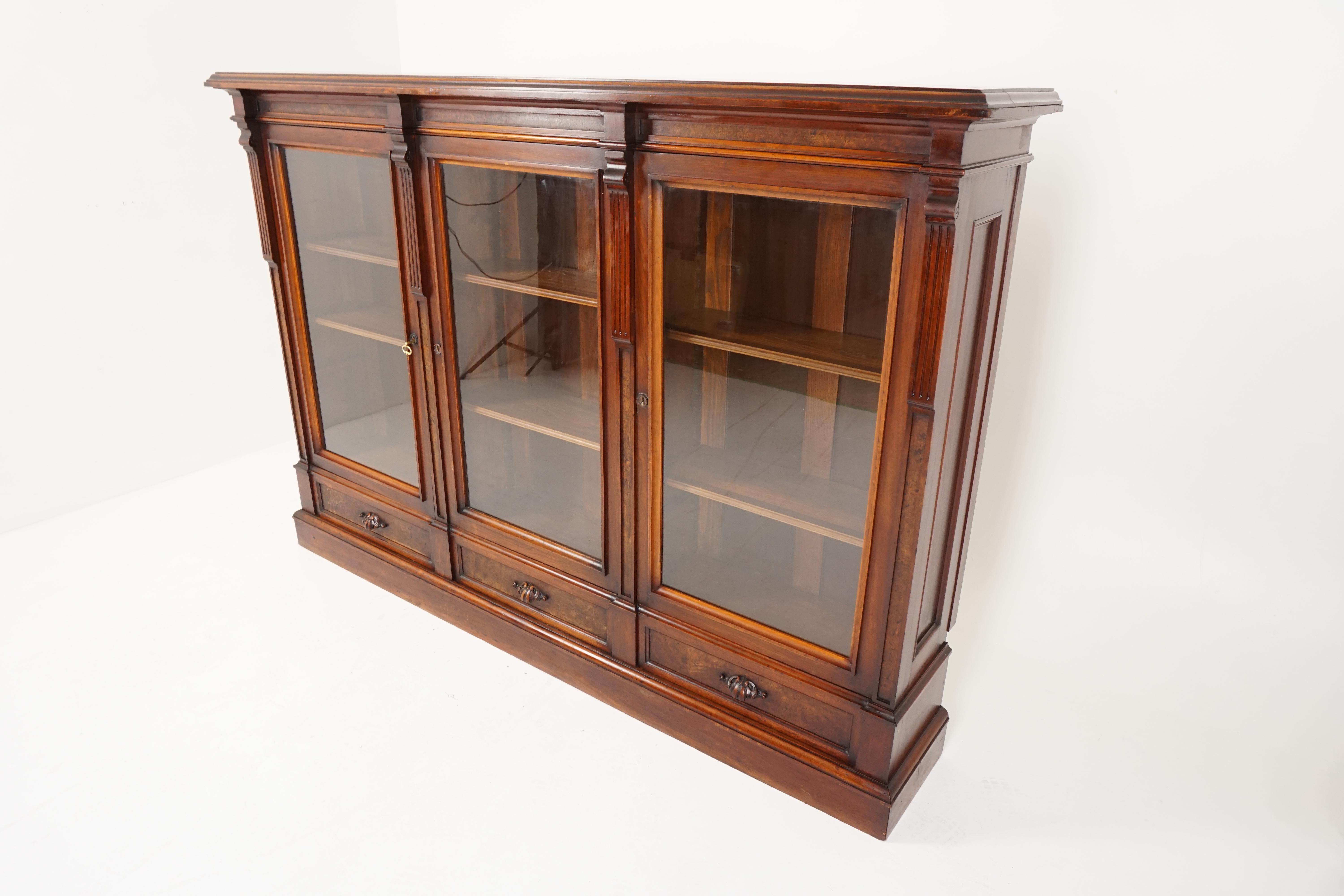 Antique Victorian East Lake 3 door bookcase display cabinet, America, 1880, B2564

American 1880
Solid walnut and veneer
Original finish
Rectangular moulded top
Three original glass doors open to reveal six adjustable shelves
Below are three raised