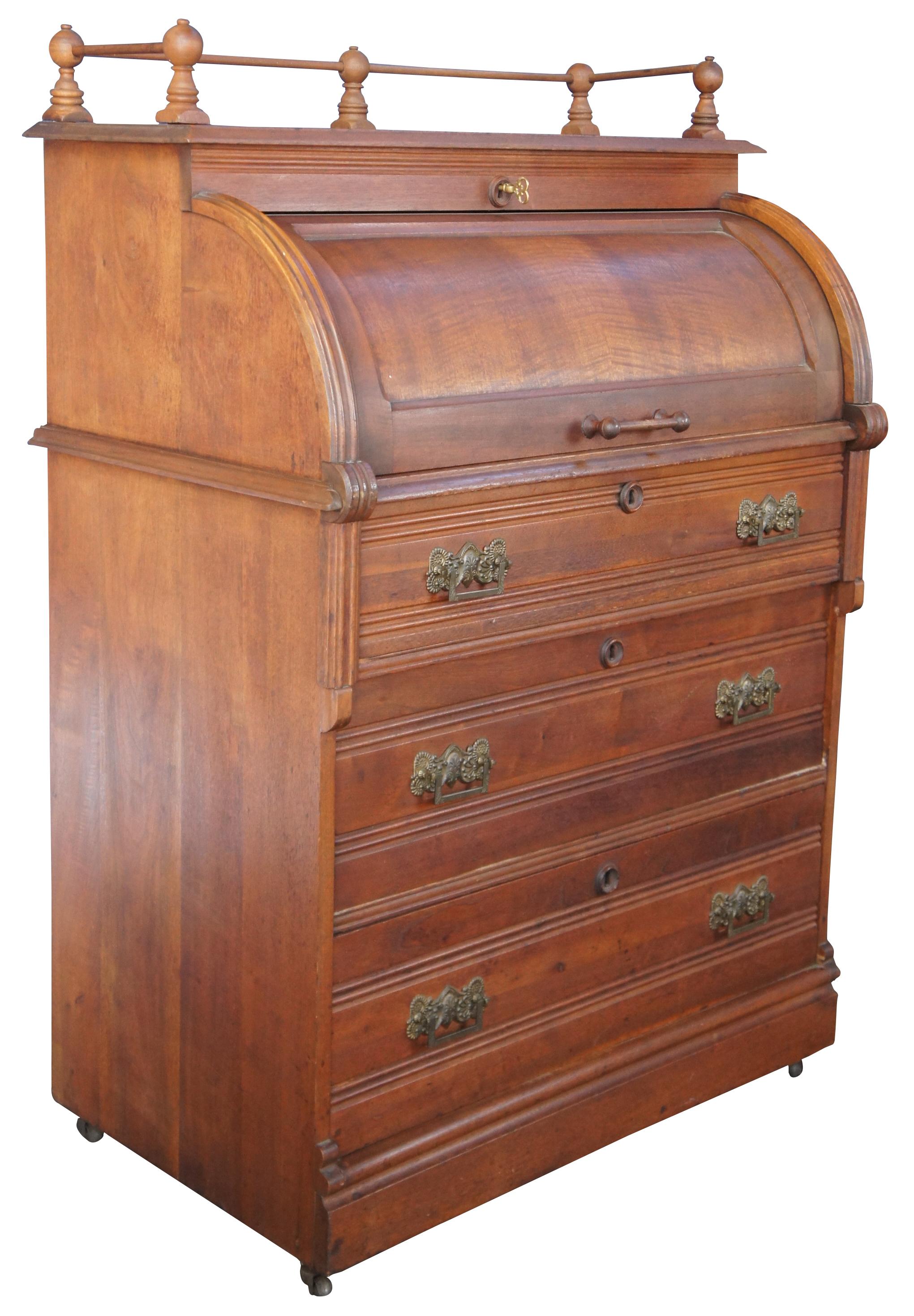 Antique 19th century Aesthetic period cylinder roll top secretary writing desk. Made of maplewood featuring lower chest with three knapp joint drawers, a roll top that opens to leather pullout writing surface with multiple drawers and cubbies, upper