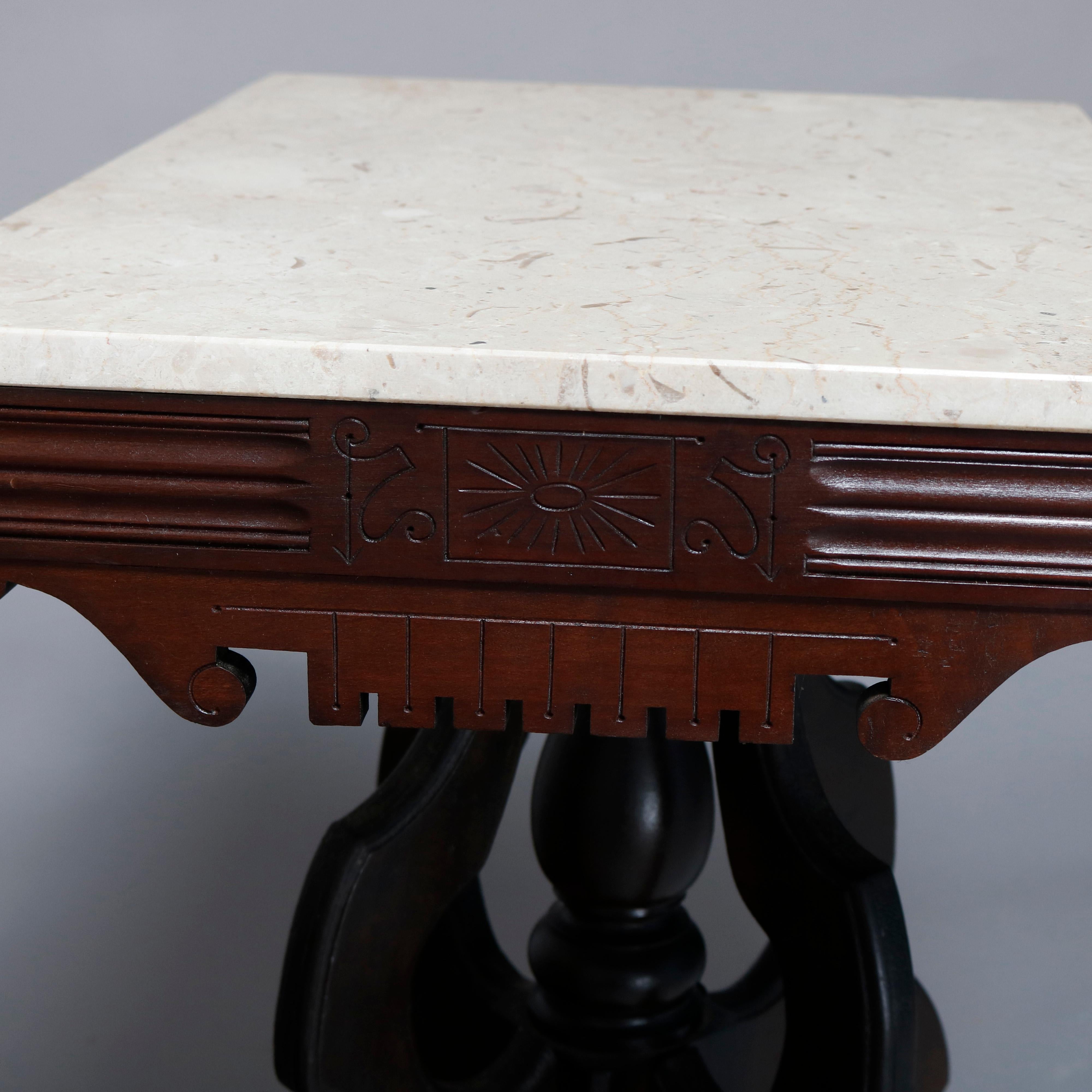 An antique Victorian Eastlake side table offers a rectangular marble top surmounting carved walnut frame having shaped skirt, raised on shaped legs with central turned column and drop finial, circa 1880

Measures: 28.75