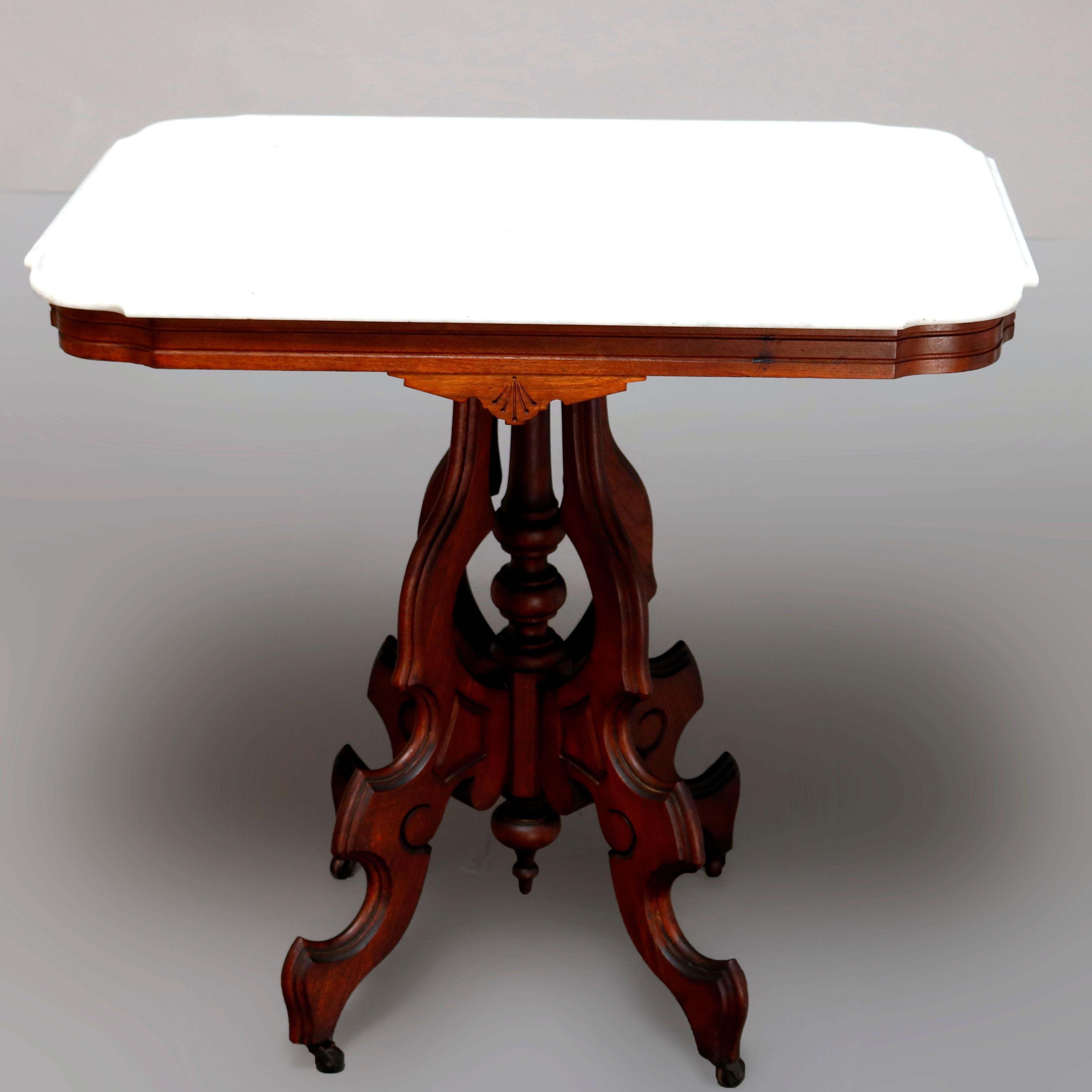 An antique Victorian Eastlake side table offers a beveled rectangular marble top surmounting carved walnut frame having shaped skirt with inset, raised on shaped legs with central turned column and drop finial, circa 1880


Measures: 29.5