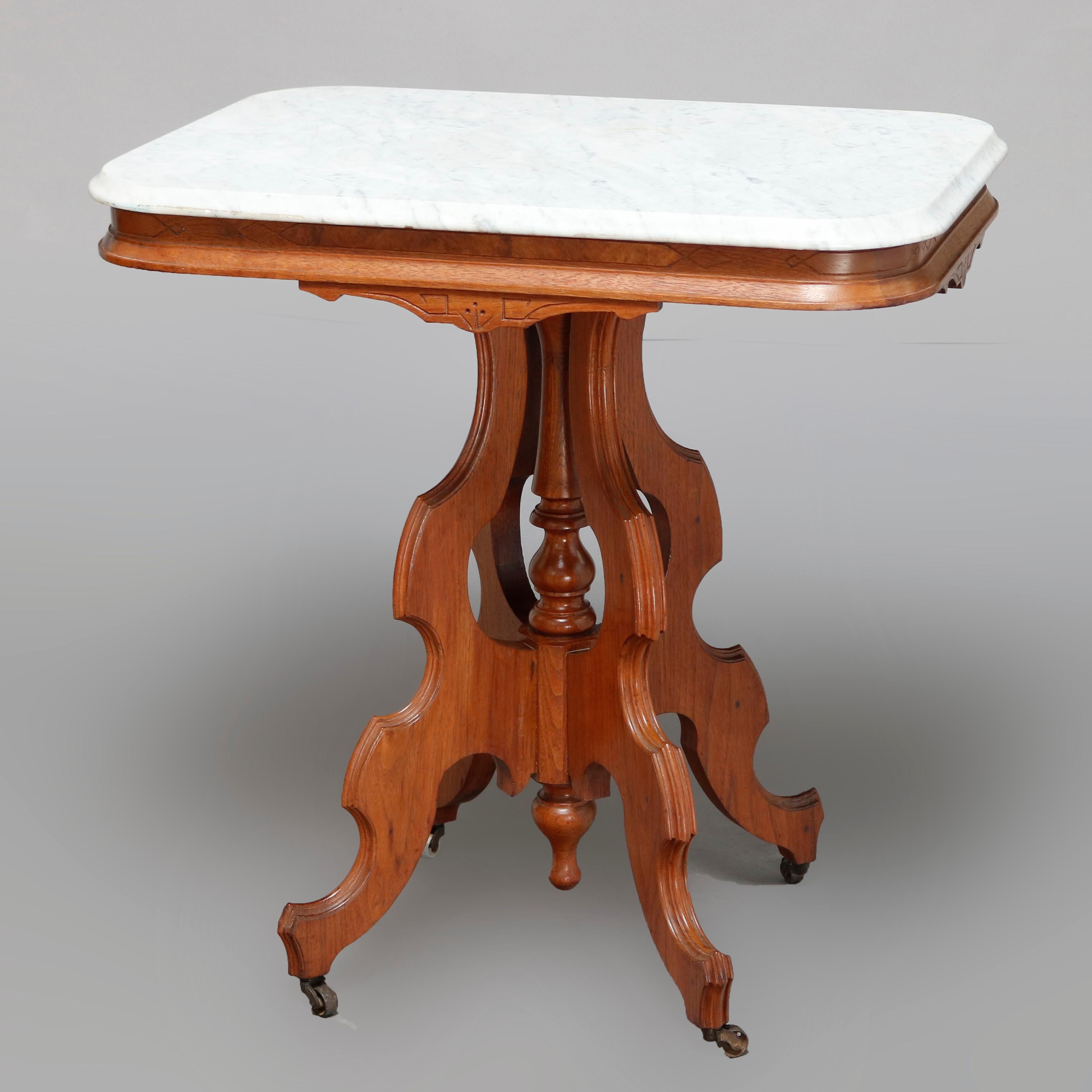 An antique Victorian Eastlake side table offers a beveled rectangular marble top surmounting carved walnut frame having shaped skirt, raised on shaped legs with central turned column and drop finial, circa 1880


Measures: 29.5