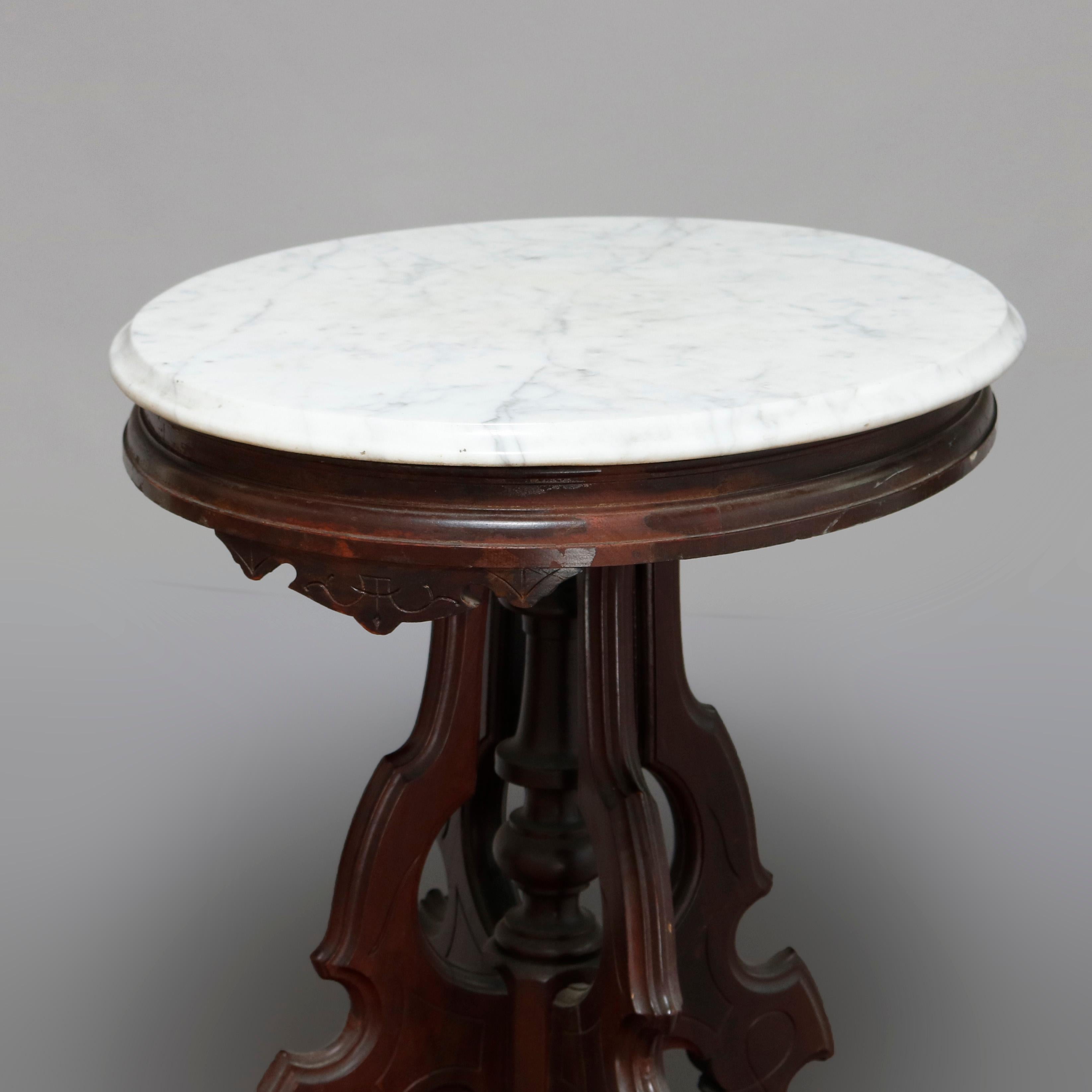 An antique Victorian Eastlake side table offers a beveled oval marble top surmounting carved walnut frame having shaped skirt raised on scroll legs with central turned column, circa 1880

***DELIVERY NOTICE – Due to COVID-19 we have employed