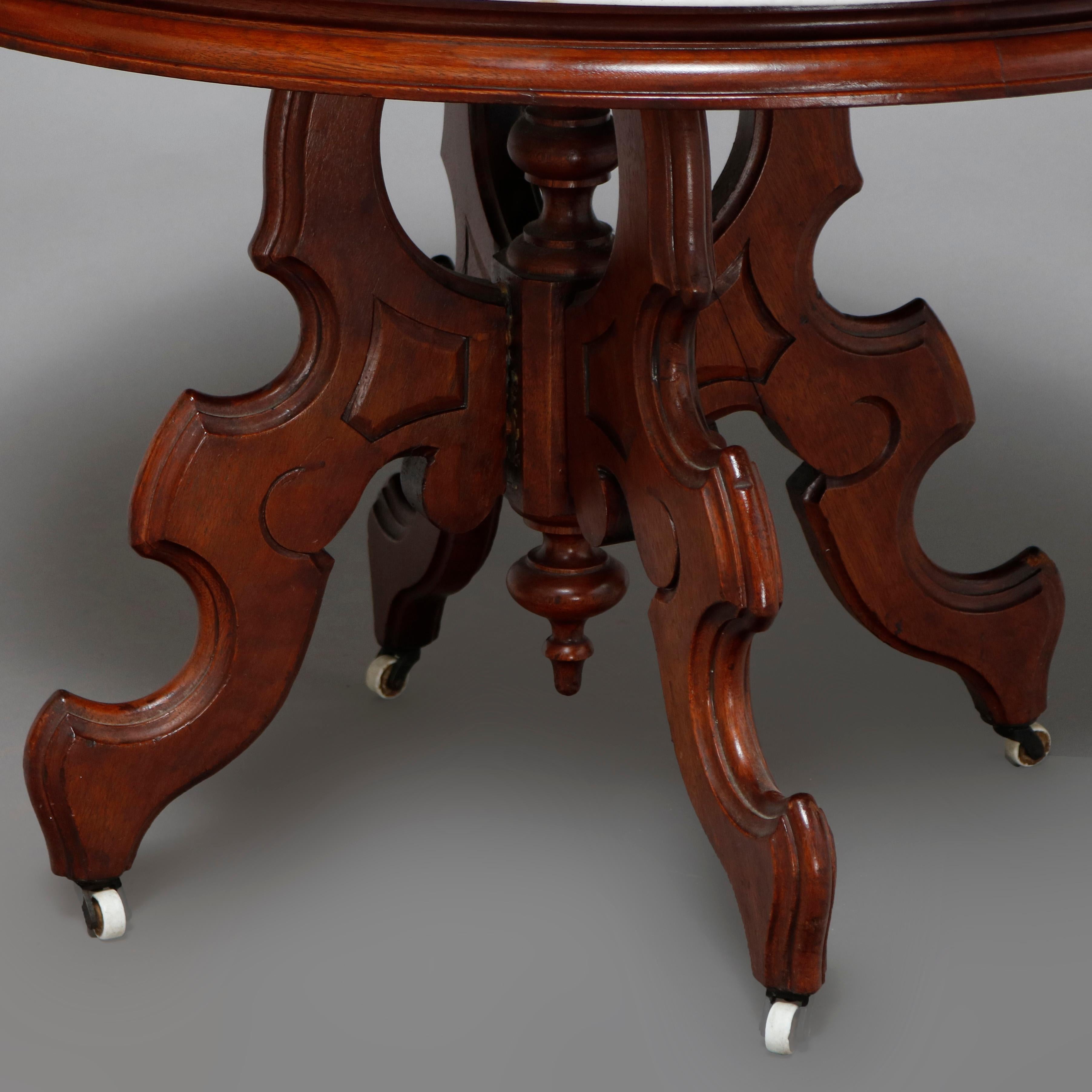 An antique Victorian Eastlake side table offers a beveled oval marble top surmounting carved walnut frame having stepped skirt, raised on shaped legs with central turned column and drop finial, circa 1880

***DELIVERY NOTICE – Due to COVID-19 we are