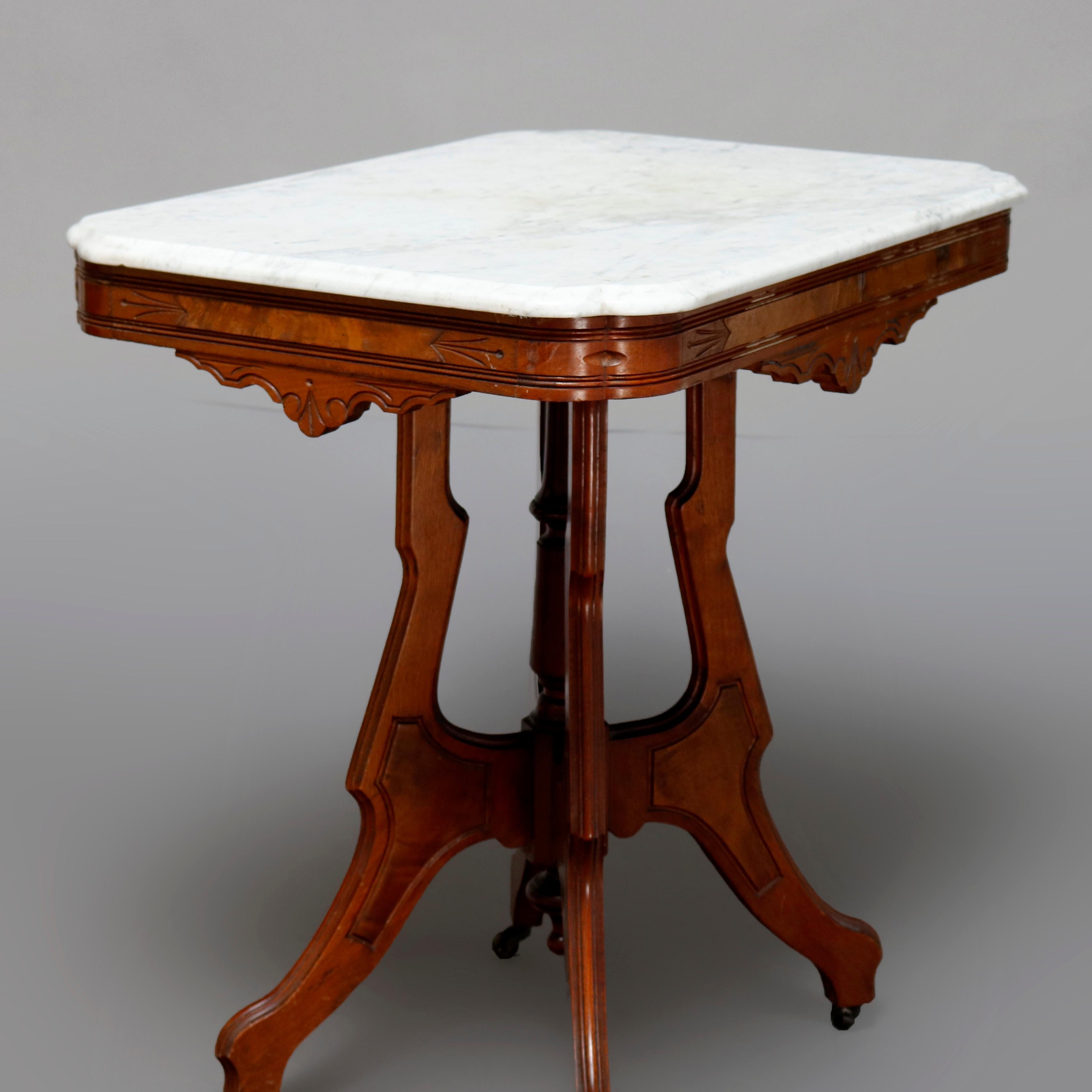 An antique Victorian Eastlake side table offers a beveled rectangular marble top surmounting carved walnut frame having shaped skirt, raised on shaped legs with central turned column and drop finial, circa 1880


Measures: 30