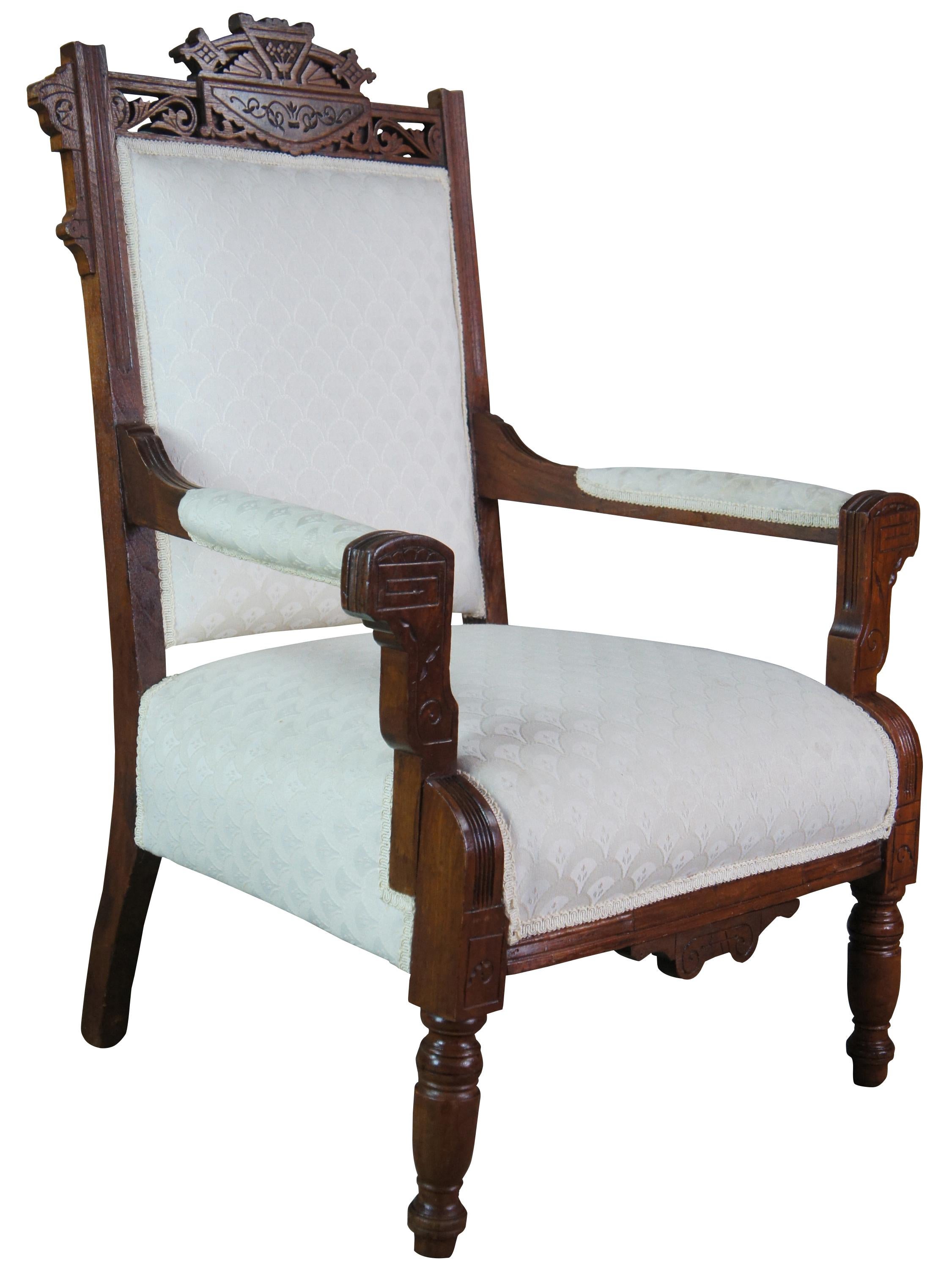 Antique Victorian parlor armchair. Made of walnut with carved Eastlake accents that features reticulated floral, turned and fluted accents.
 