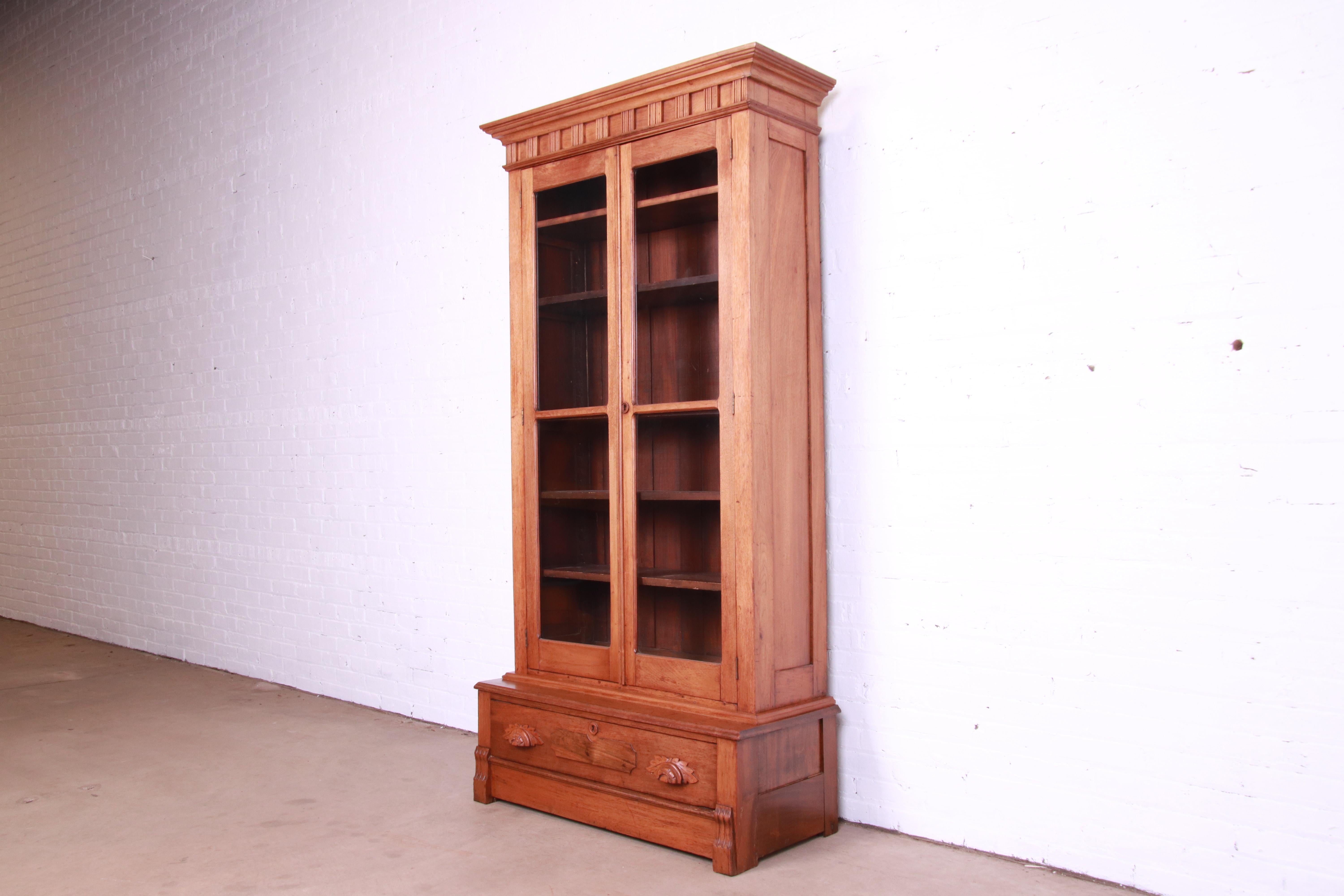 American Antique Victorian Eastlake Carved Walnut Glass Front Bookcase, Circa 1880s