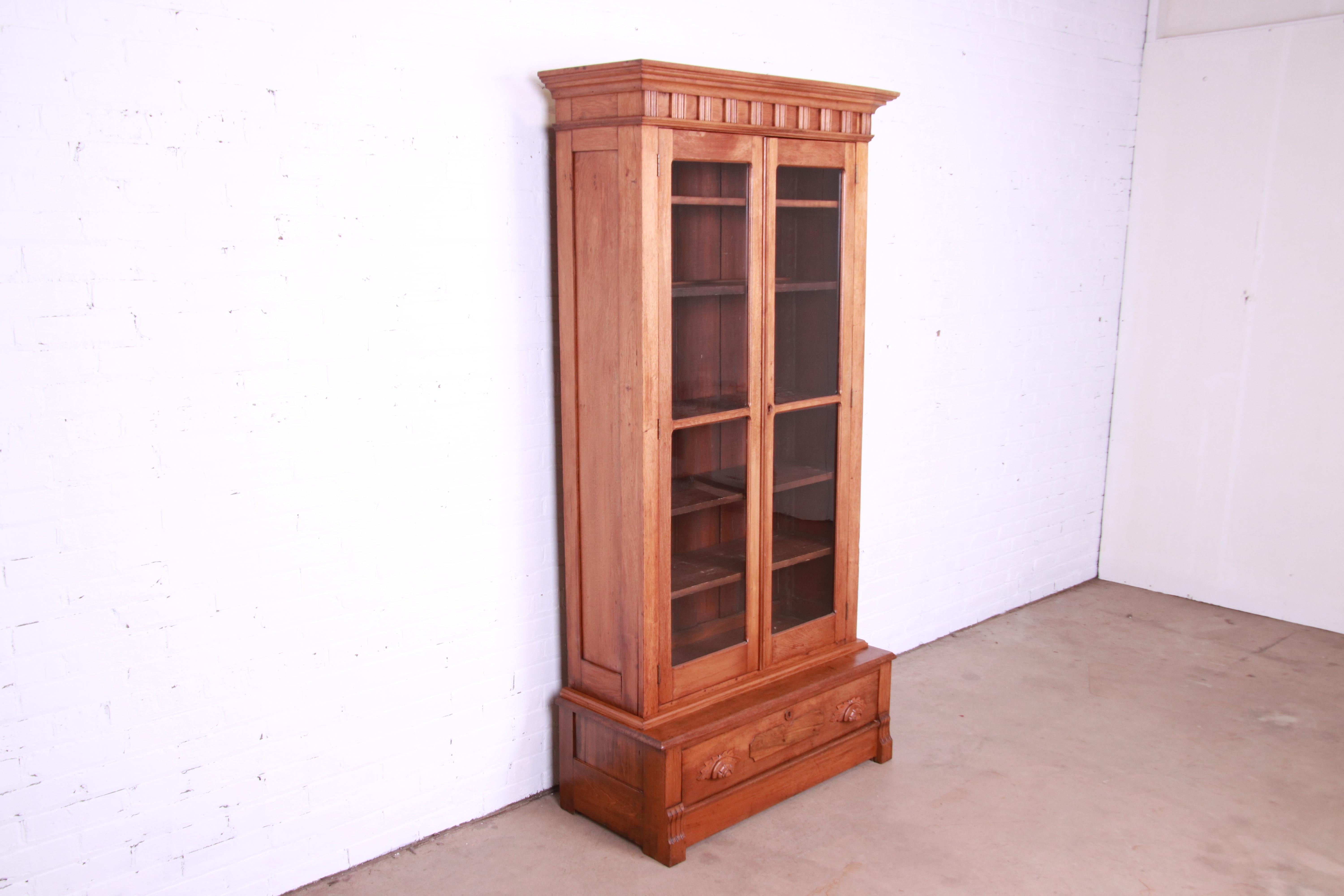 Antique Victorian Eastlake Carved Walnut Glass Front Bookcase, Circa 1880s In Good Condition In South Bend, IN