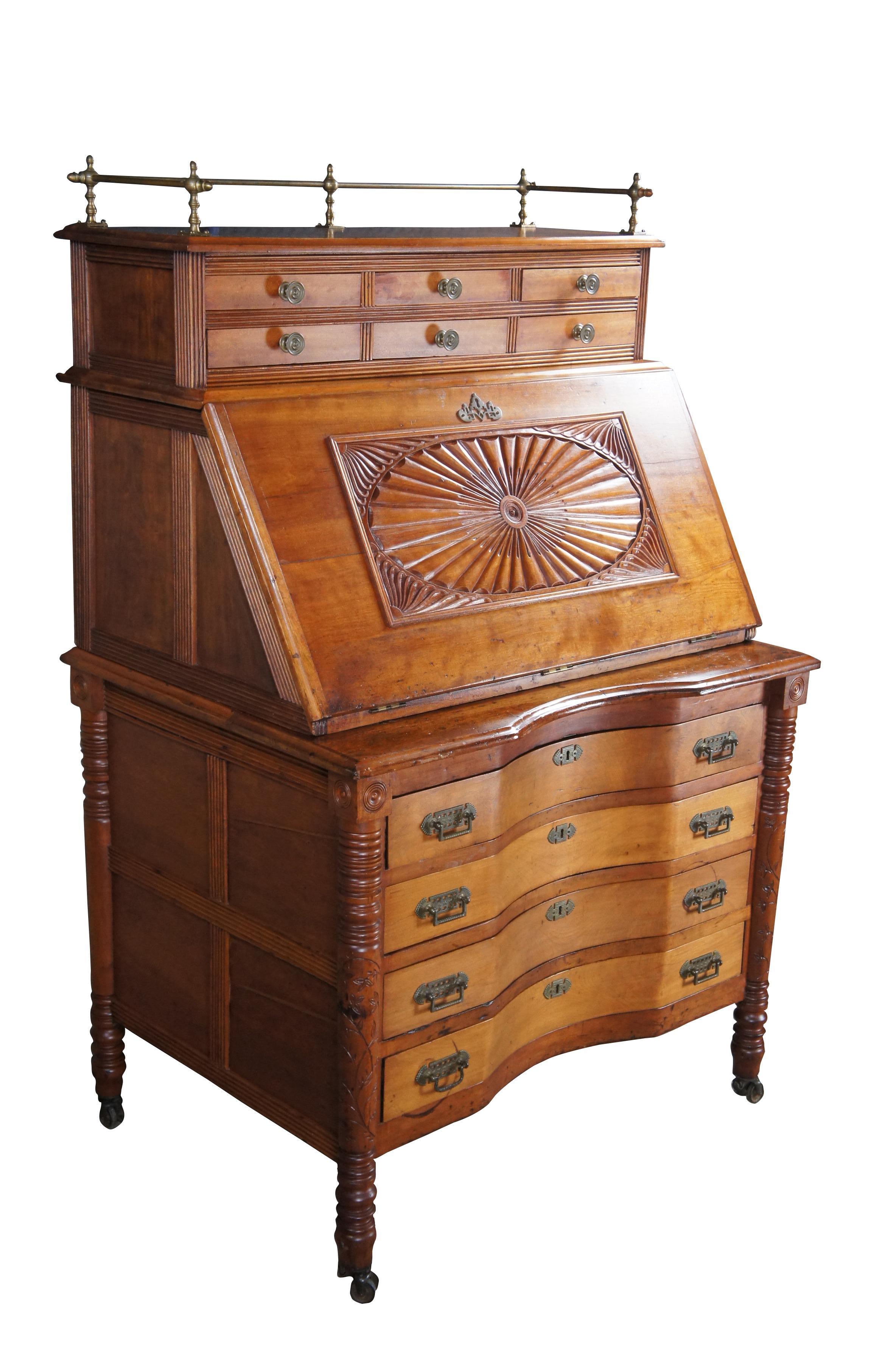 Antique Victorian drop front secretary or library writing desk.  Made of cherry featuring Eastlake styling with upper brass gallery and six apothecary style drawers over a slanted drop front that opens to multiple cubbies and storage shelves.  The