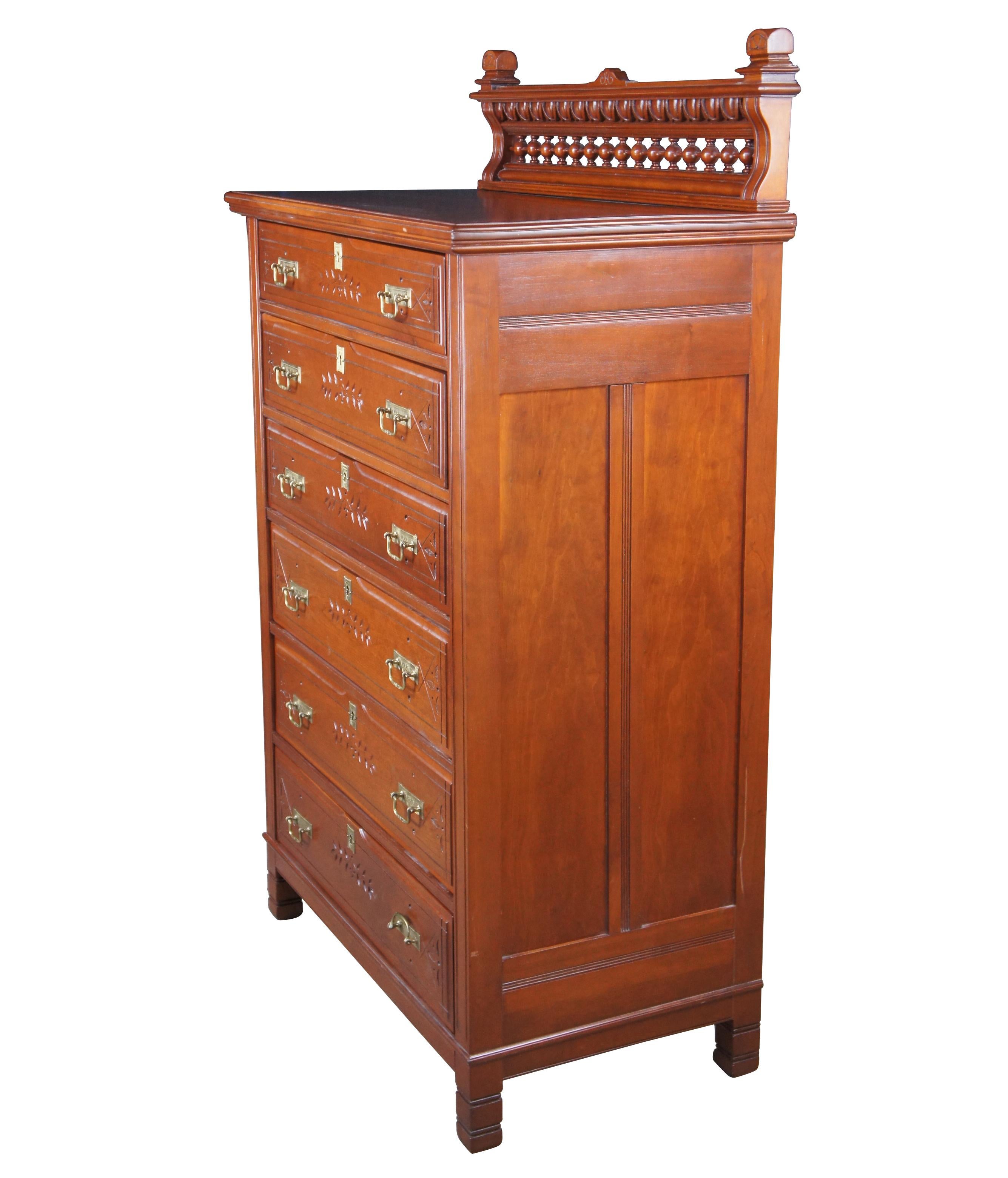 Impressive 19th century cherry highboy dresser, circa 1880s.  Features 6 dovetailed drawers, carved with leaf and vine motif, ornate brass bale hardware and matching escutcheon plates.  Stiles and drawer fronts have decorative shallow engraved lines