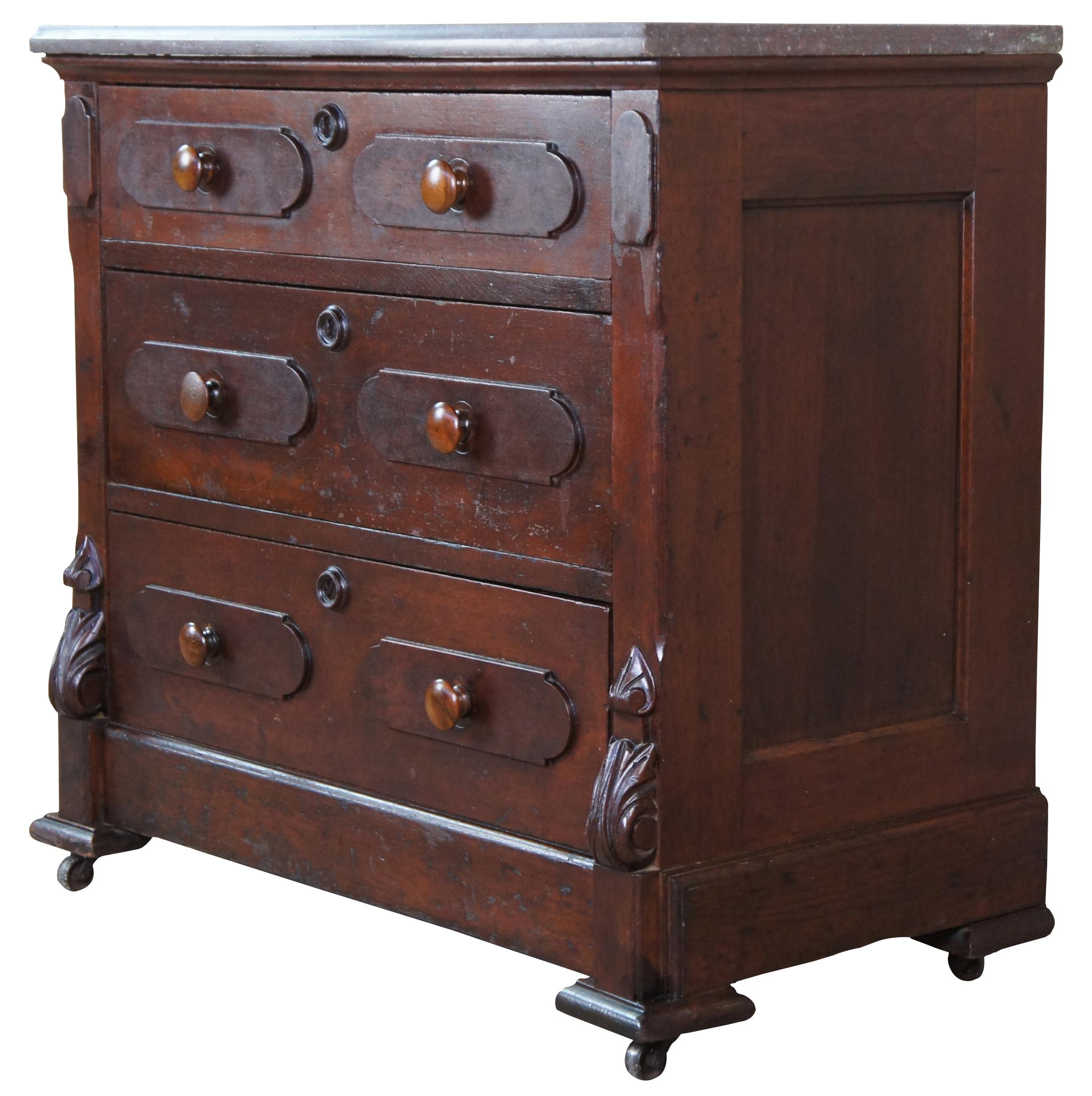 Antique Victorian Eastlake dresser or chest of drawers. Made of walnut featuring three (3) drawers with raised burled panels, turned knobs, acanthus carved accents, and granite top over square feet with castors.
  
