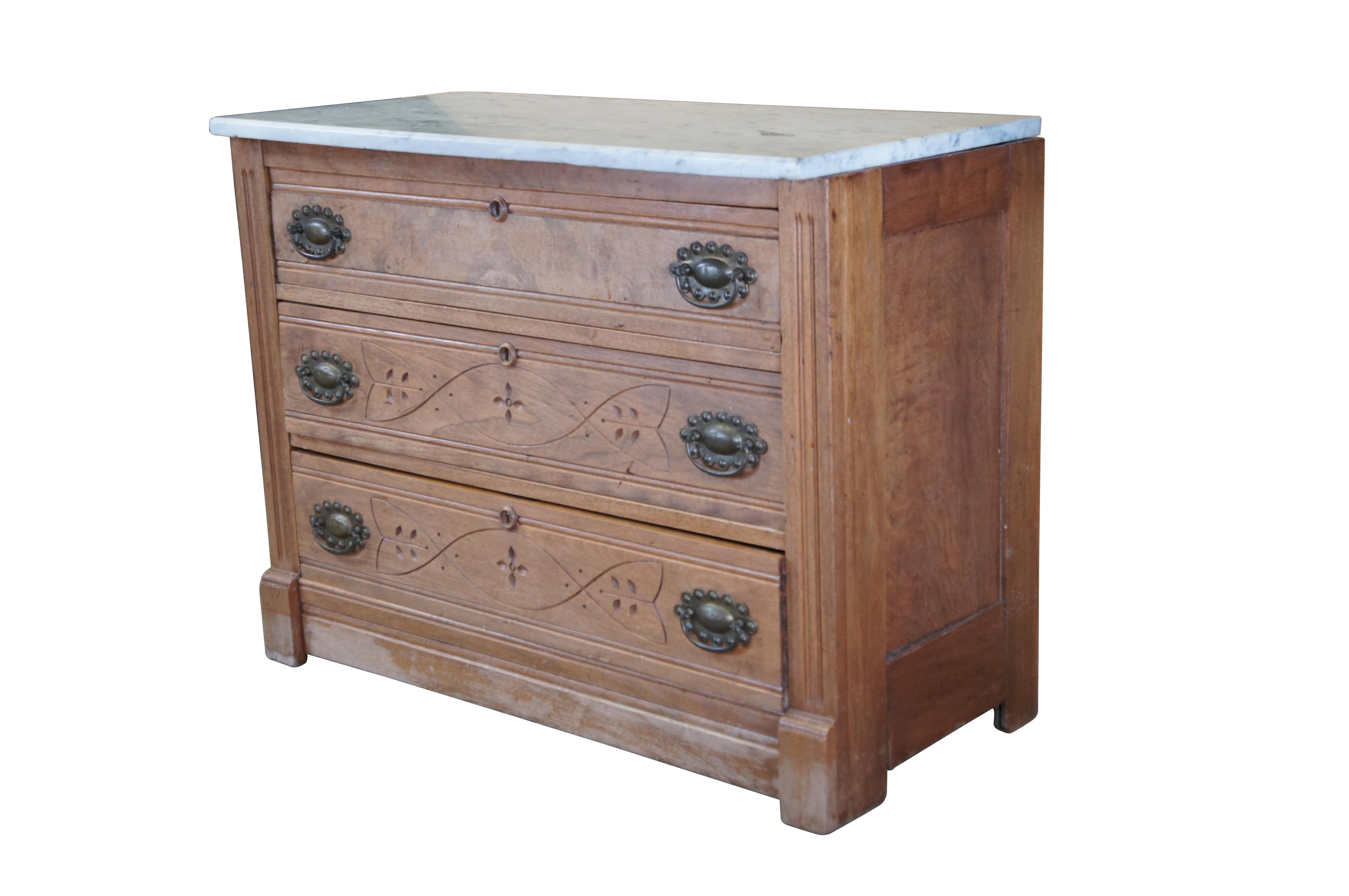 Late Victorian Eastlake Chest of Drawers. Features a walnut frame with three dovetailed drawers with round escutcheon plates and brass hardware. The uppermost drawer has walnut burl veneered front, and the lower two are engraved with a foliate