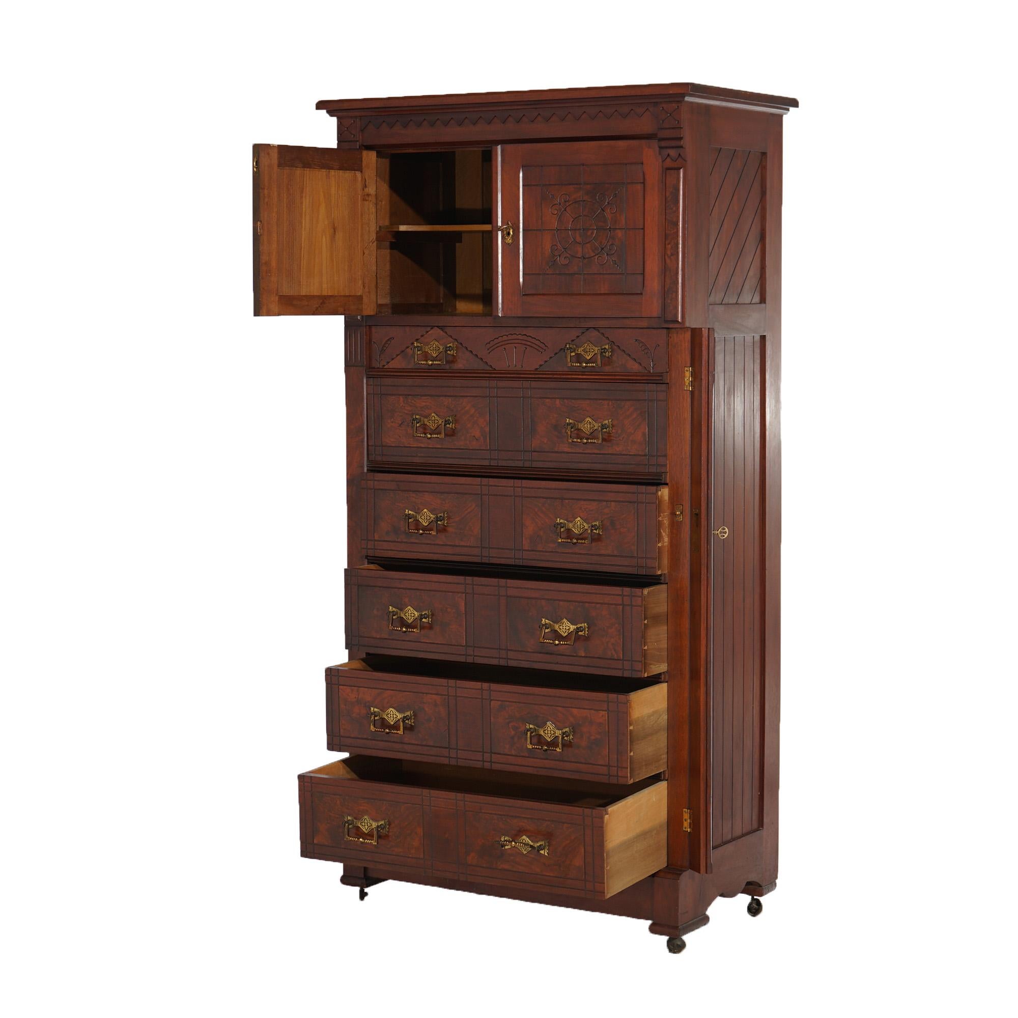 An antique Victorian Eastlake tall chest offers walnut construction with burl panels, incised decoration, and having upper double door cabinet over five long drawers, c1890

Measures- 67.5''H x 34.5''W x 19''D