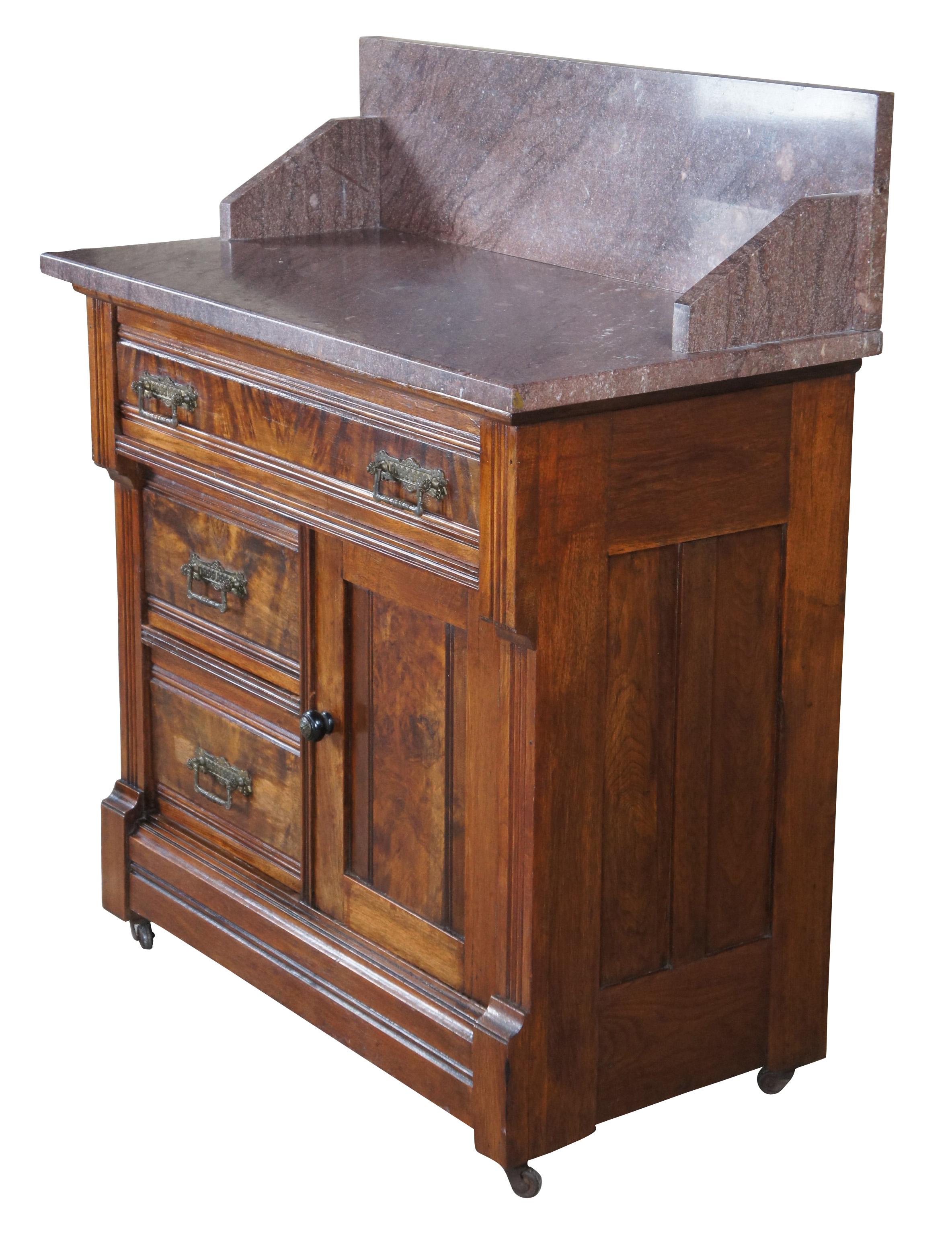 Antique Victorian wash stand / chest / side table. Made of walnut featuring Eastlake styling with marble top backsplash over three drawers and one cabinet accented with walnut burl panels and brass hardware.

Measures: 30.5