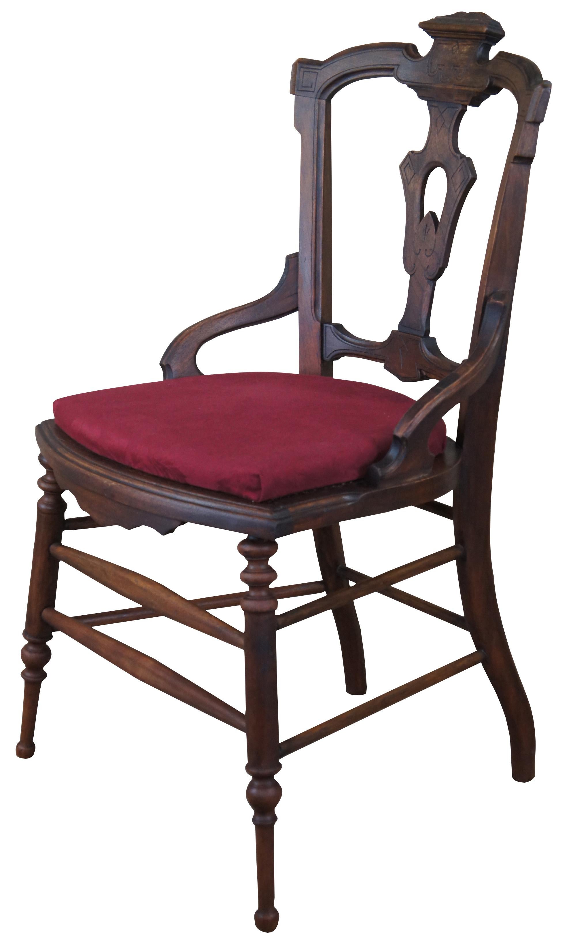 Antique Victorian Eastlake dining parlor chair. Made of walnut featuring ornate design with carved accents and turned legs.
 