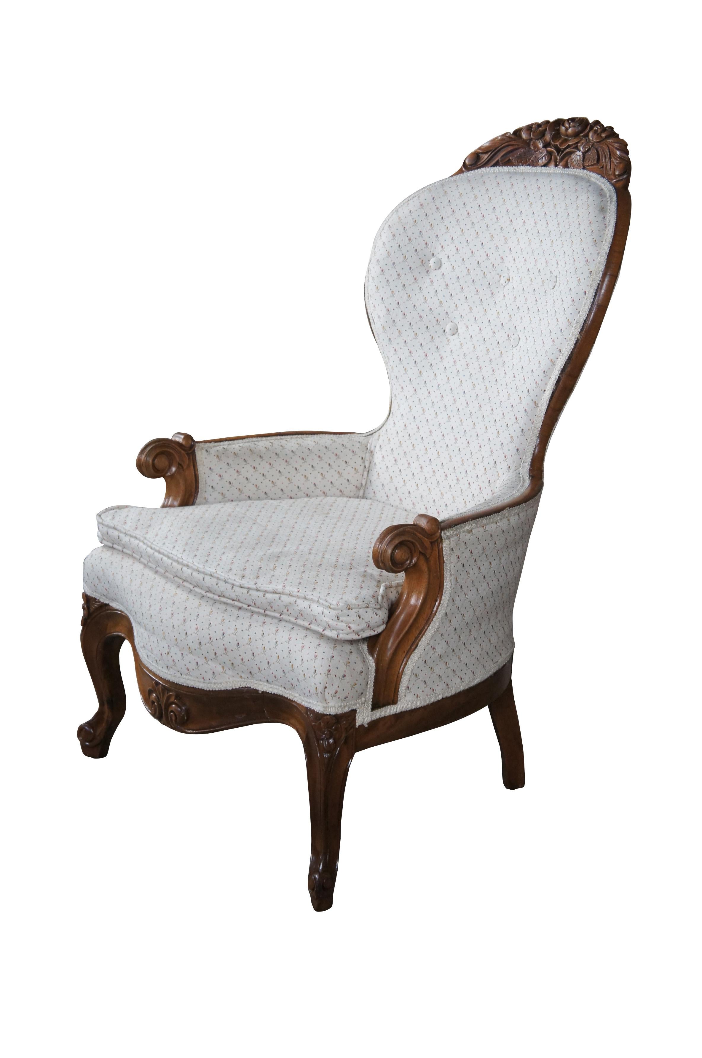 Antique Victorian Eastlake spoon back armchair.  Made of walnut featuring serpentine form with low relief carved floral crown, tufted back, scrolled arms and cabriole legs.

Dimensions:
35