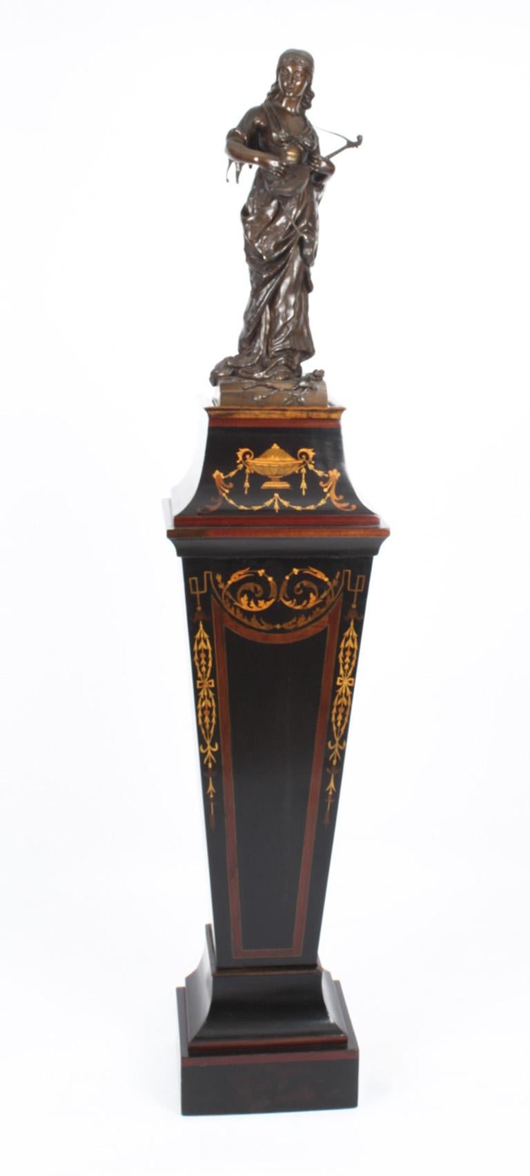 A superb late Victorian ebonised, crossbanded and marquetry pedestal, C1890 in date.

The pedestal superbly inlaid with a marquetry of ribbon tied urns, scrolling leaves and husks, with an inset marble top.

Condition:
In excellent condition