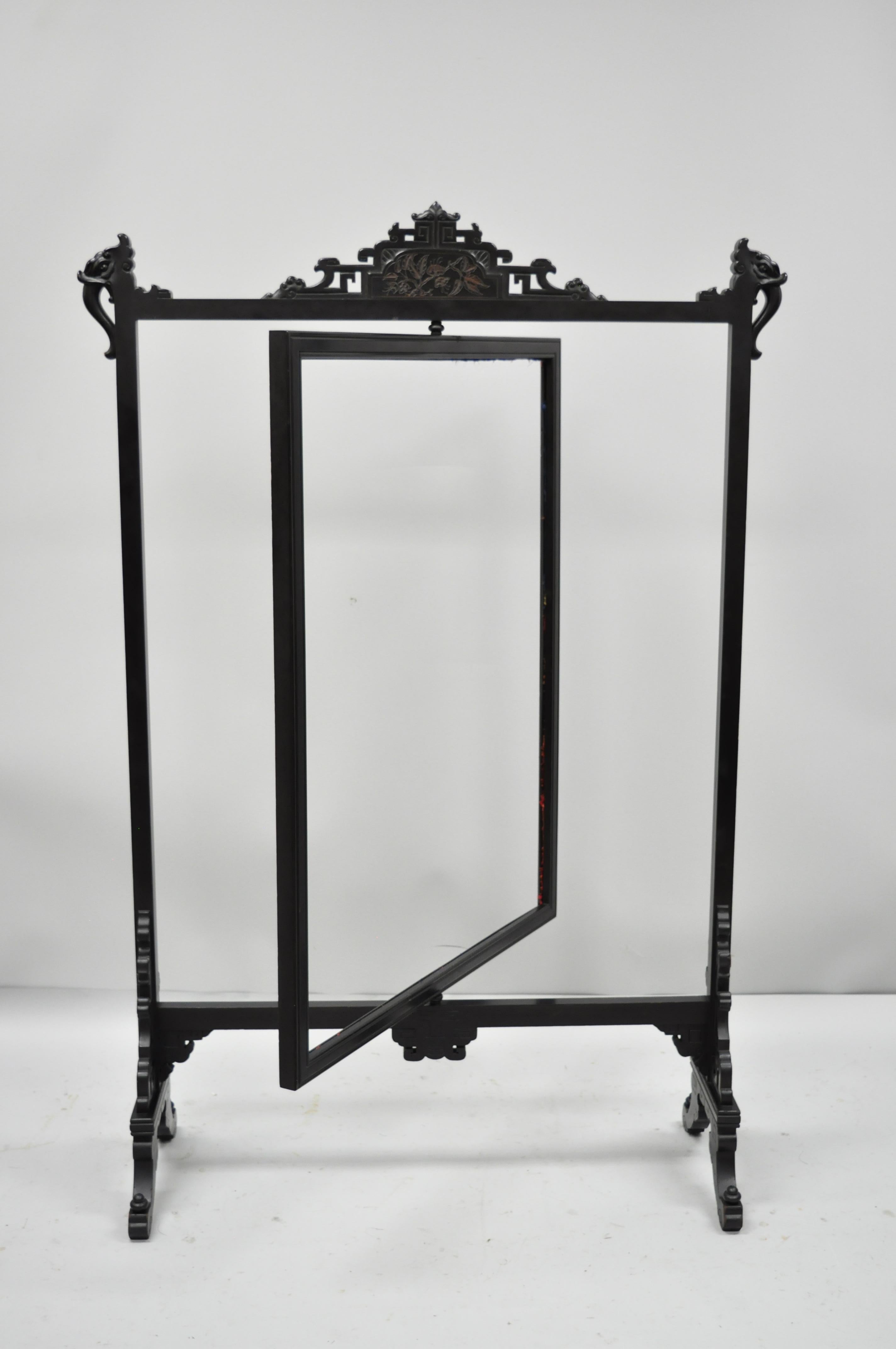 Antique Victorian ebonized oriental revolving firescreen. Item features revolving centre panel (to be reupholstered), open pediment and base, ebonized finish, solid wood frame, very nice antique item, circa early 20th century. Measurements: 51