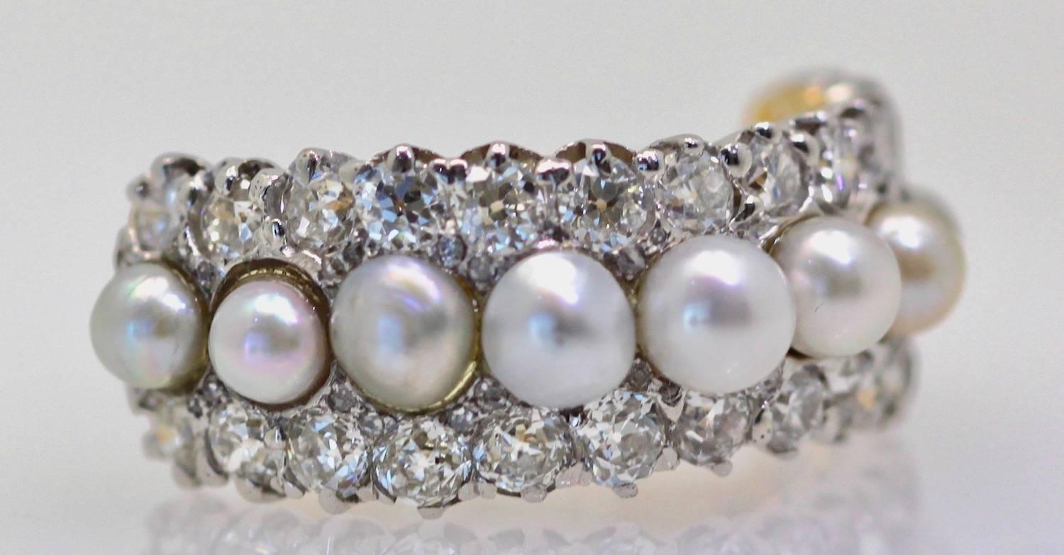 I just love this ring. This is circa 1910-1919 and there are 9 slightly silver Pearls. These are not a perfect match but they are original to the ring. There are also 30 Diamonds on each side of the Pearls. This is on a 18K gold base with a silver
