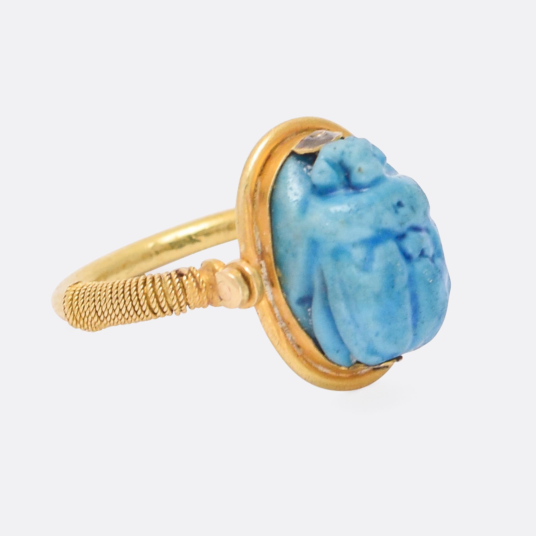 A cool antique Egyptian Revival scarab spinner ring dating from the 1870s. The scarab is a vivid blue colour, and formed from faience. It's set in 15k gold, with rope-work detail to the shoulders.

The term faience broadly encompassed finely glazed