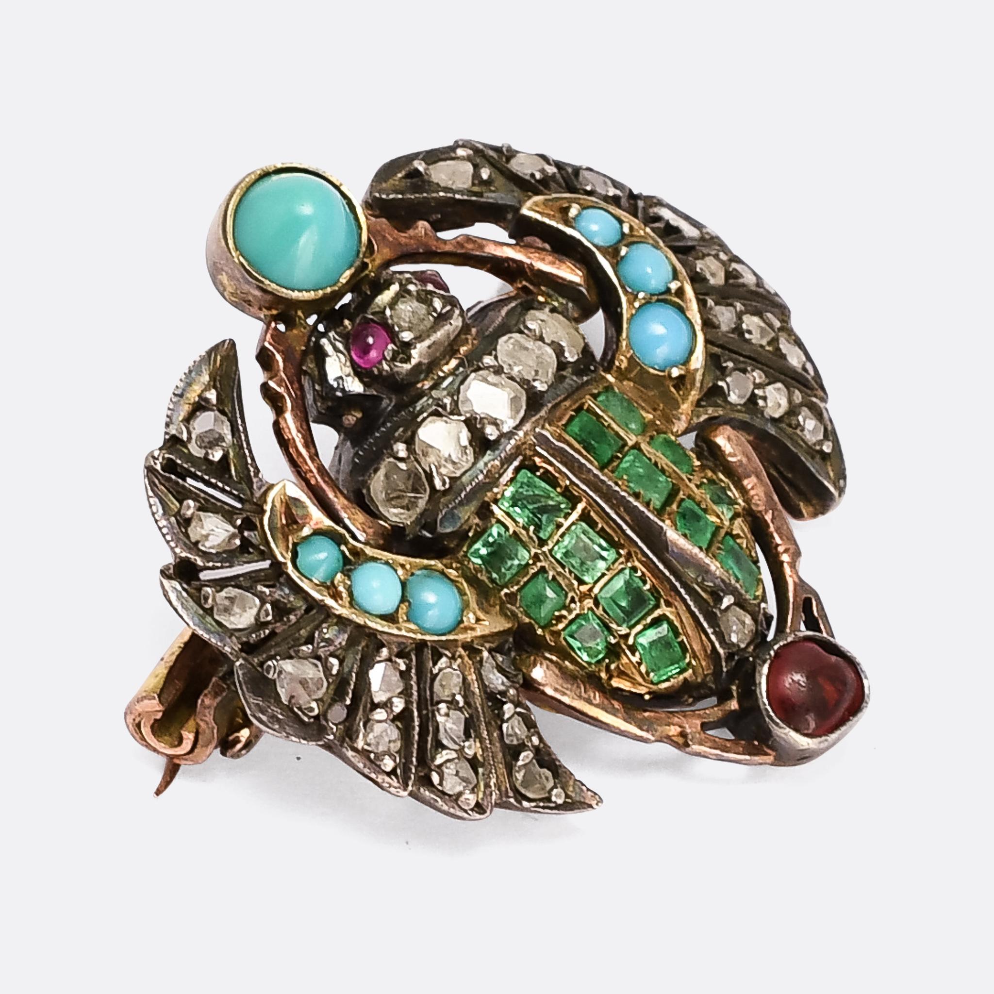 An incredible Victorian Egyptian Revival winged scarab brooch dating from the 1880s. It's expertly crafted, and set with an array of coloured gemstones, including emerald, ruby, and turquoise, as well as rose cut diamonds. The scarab was highly