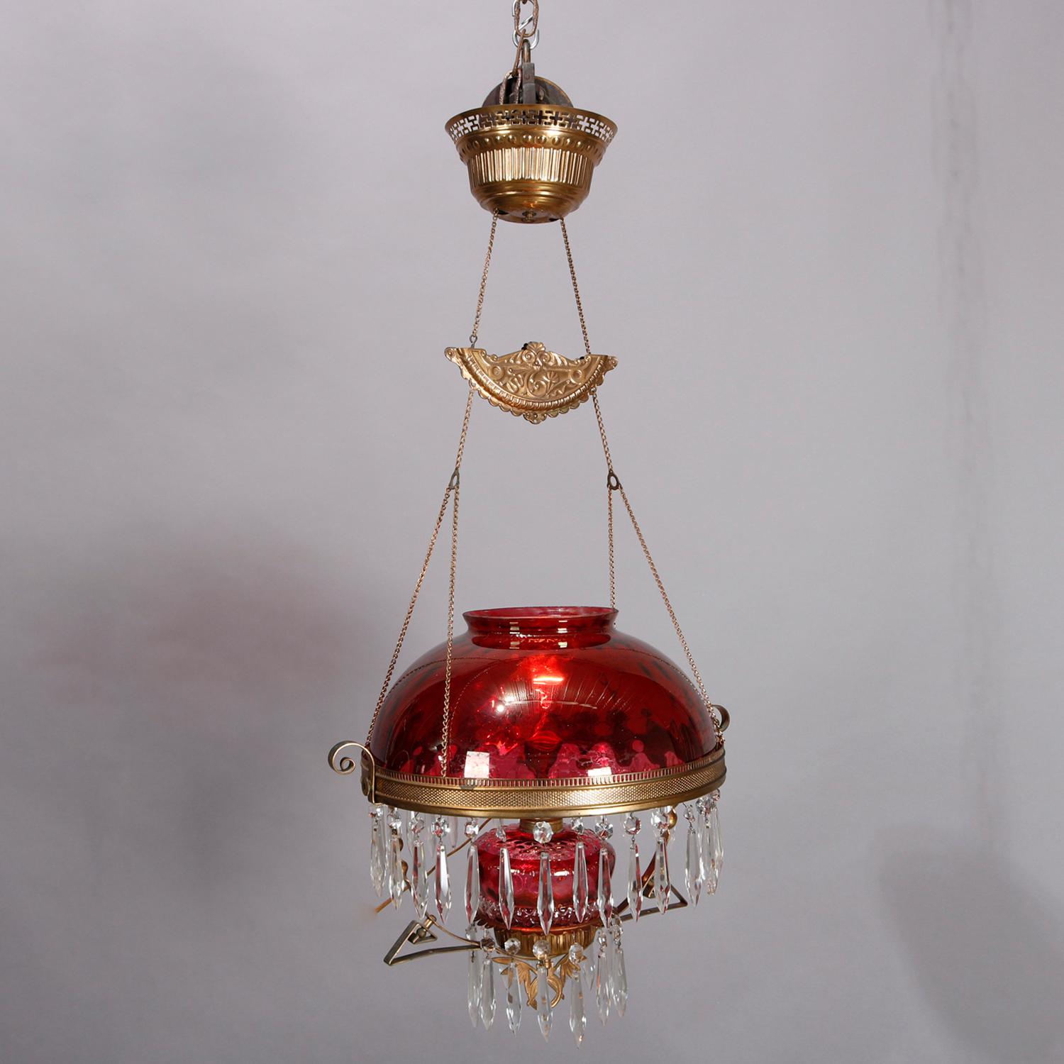 An antique Victorian hanging banquet light offers cranberry glass shade and font in brass frame and having cut crystal prisms, electrified, circa 1890

***DELIVERY NOTICE – Due to COVID-19 we are employing NO-CONTACT PRACTICES in the transfer of