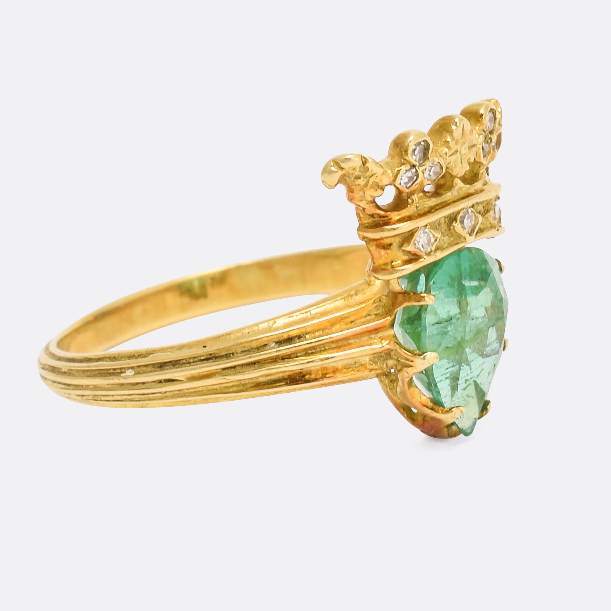 A superb antique crowned heart ring dating from the late Victorian era. The heart-shaped emerald rest beneath a gleaming diamond-set crown - all intricately worked with a great level of detail. Modelled in 18 karat gold with am interesting grooved