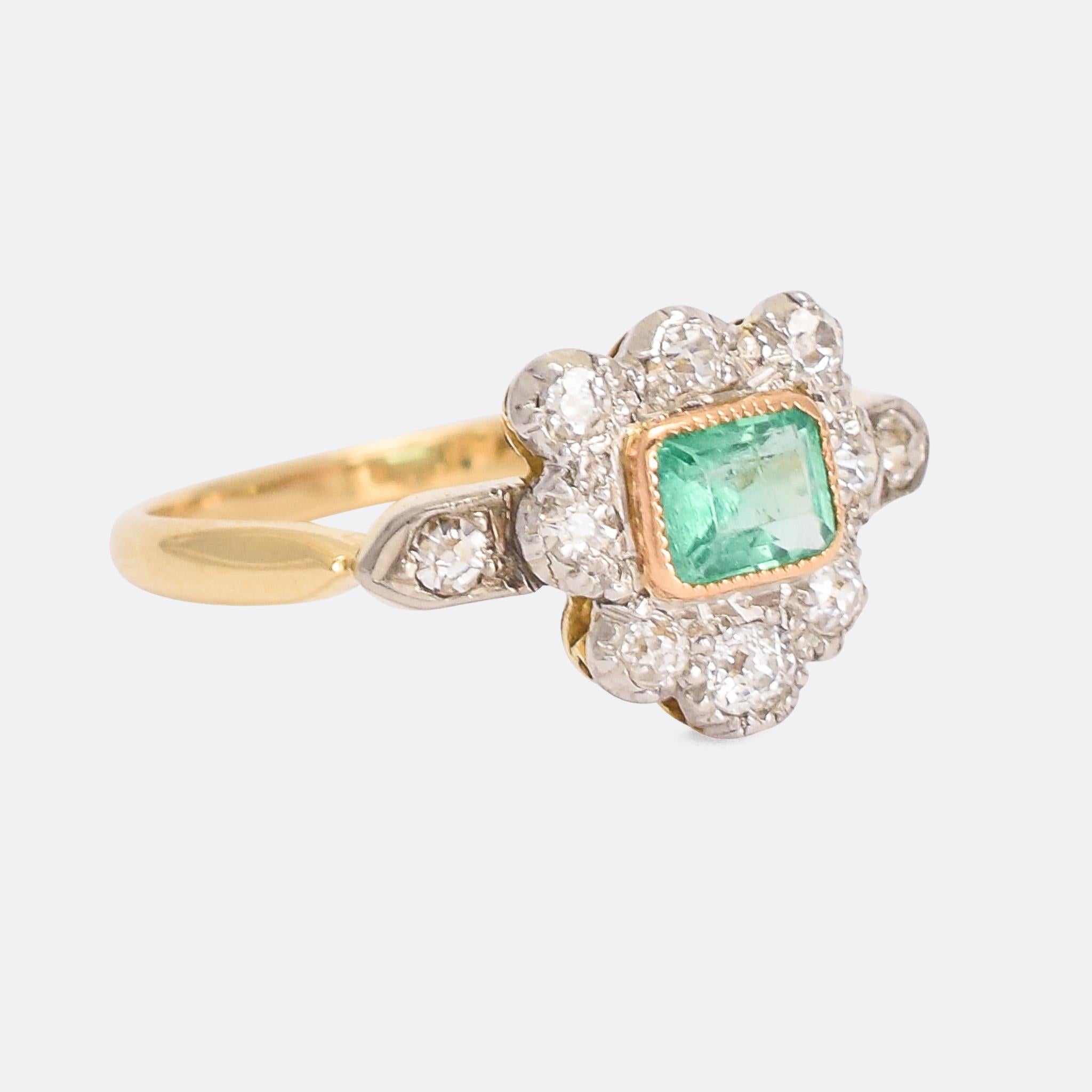 A highly unusual antique cluster ring dating from the late Victorian era. The head is a shield (or heart?) shape, and set with old cut diamonds around a central emerald. Very strange to see an asymetrical cluster ring from this period, but it's