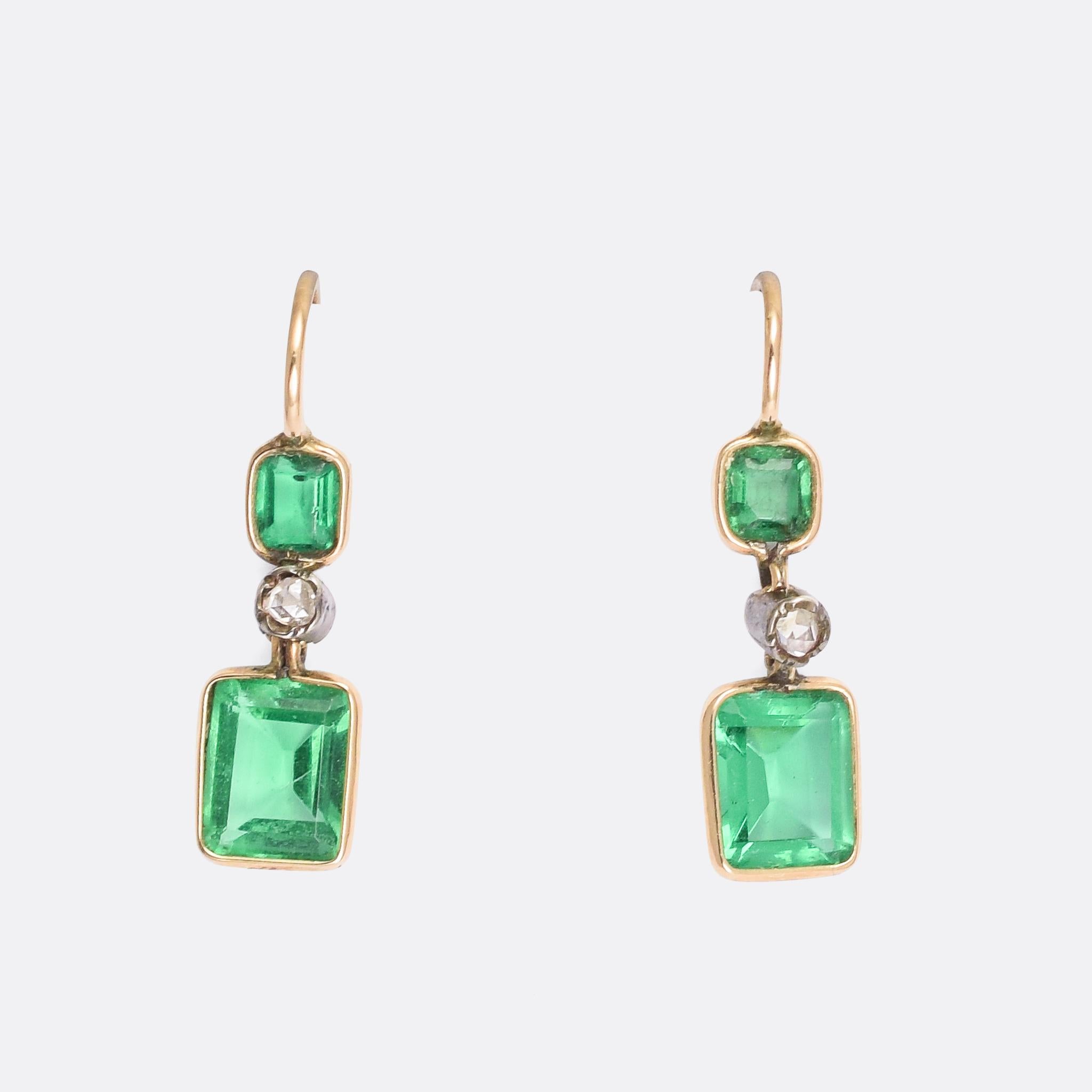A gorgeous pair of antique emerald paste and rose cut diamond earrings dating from the late Victorian era, circa 1900. The stones rest in simple collet settings; 15 karat gold for the pastes, and sterling silver for the diamonds. They're elegant but