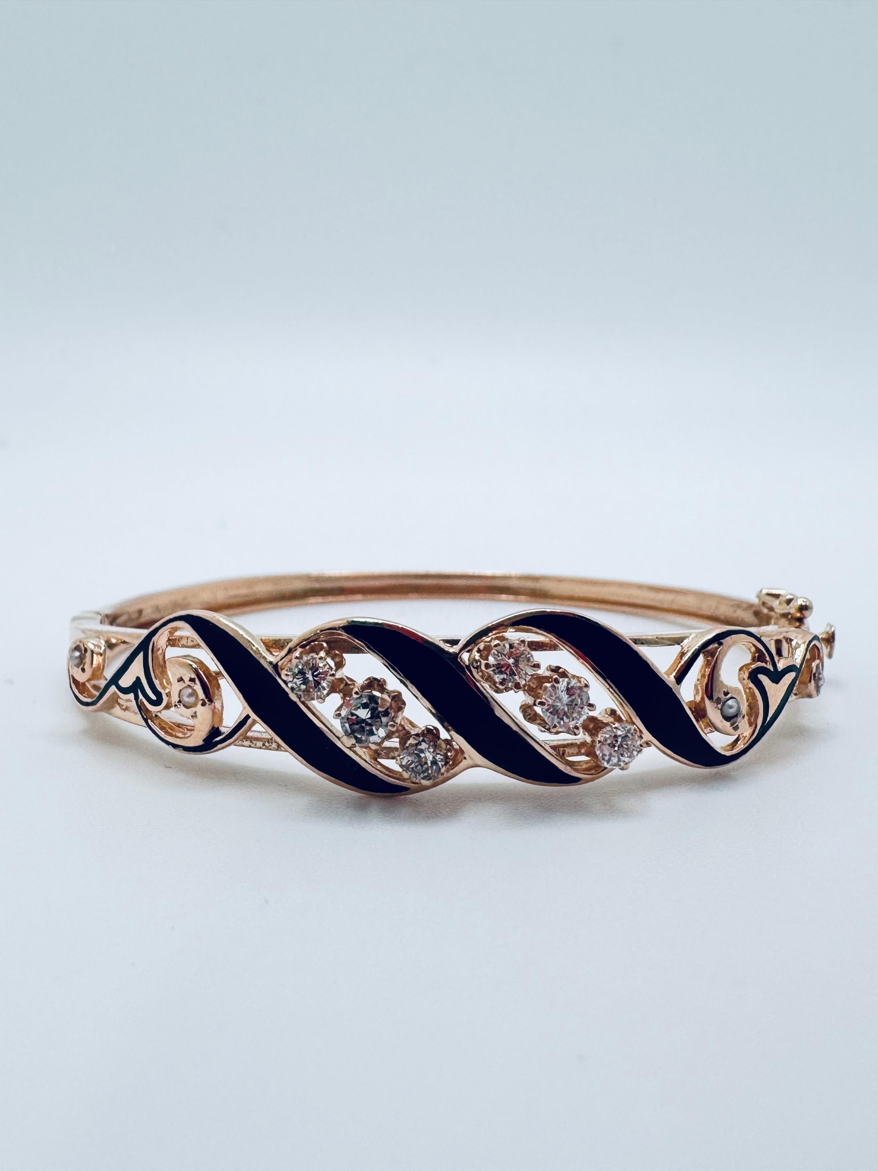 A Victorian-era rose gold bangle, dating from approximately 1837 to 1901, showcasing exquisite craftsmanship and classic period artistry. The piece features intricate enamel work that adds depth, color, and historic charm to its design. Set