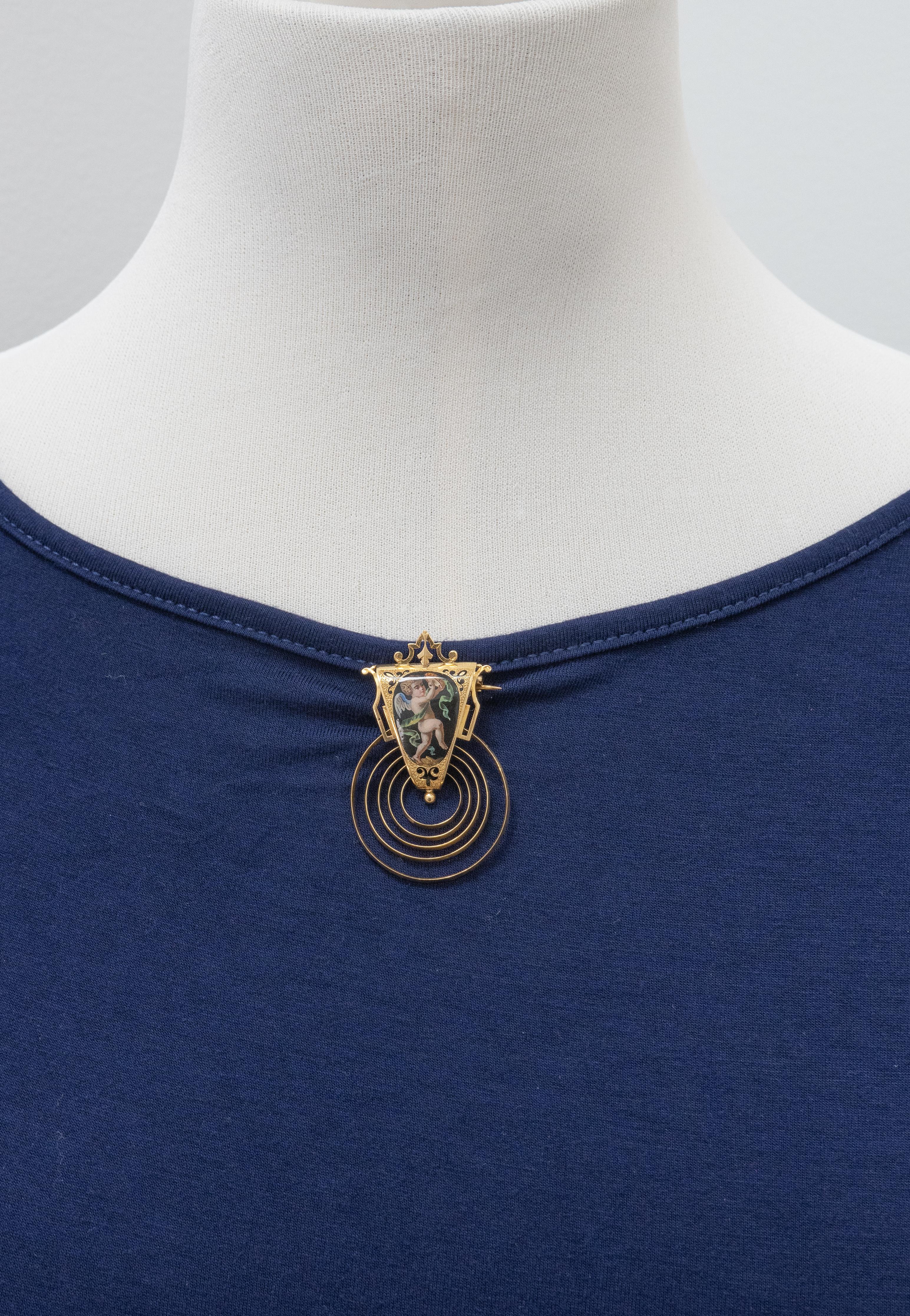 A rare and exquisite set of Victorian 18K yellow gold hand-printed enamel portraits of cherubs drop earrings and a matching brooch, rich in detail and romantic symbolism.

Approximate Weight: 19.3 grams

Approximate Measurements: 
Earrings - 61.0mm
