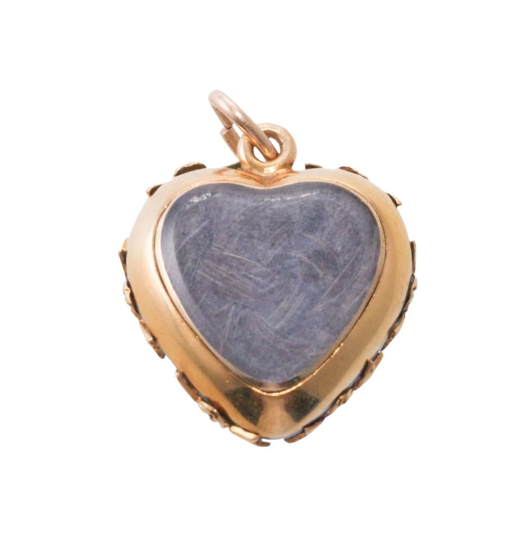 Wonderful representative of antique Victorian era Mourning jewelry, this delicate 14k gold heart pendant is set with bright turquoise blue enamel,  pearls and an old mine cut diamond in the center, weighing approx. 0.05ct, The pendant has a hair
