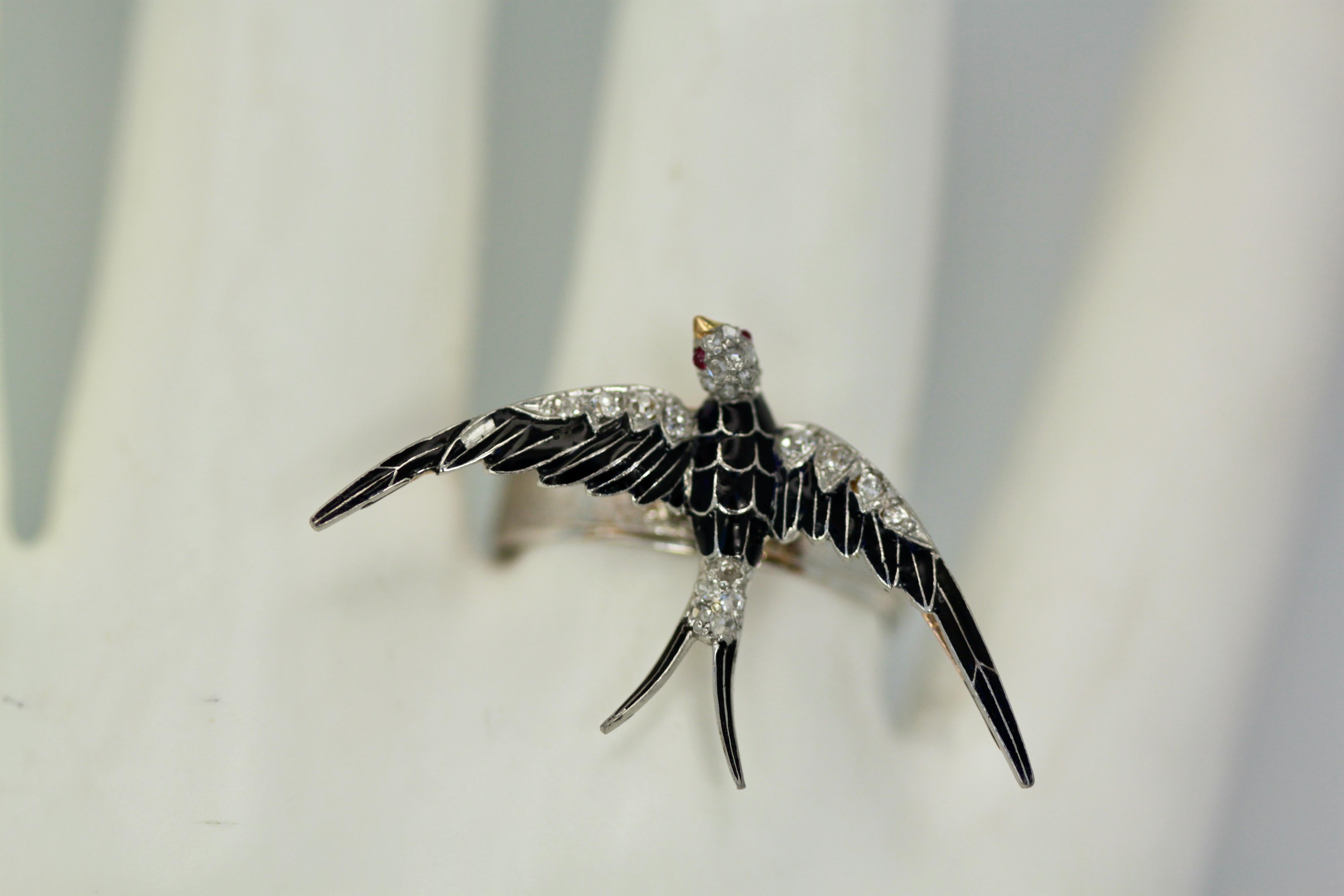 This antique Diamond Enamel Swallow started life as a brooch, which I converted to a ring.  This is black enamel on 14K Yellow Gold and set with old mine cut and rose cut Diamonds.  Cabochon Ruby set as eyes, no assay marks.  This weighs 3.9 grams