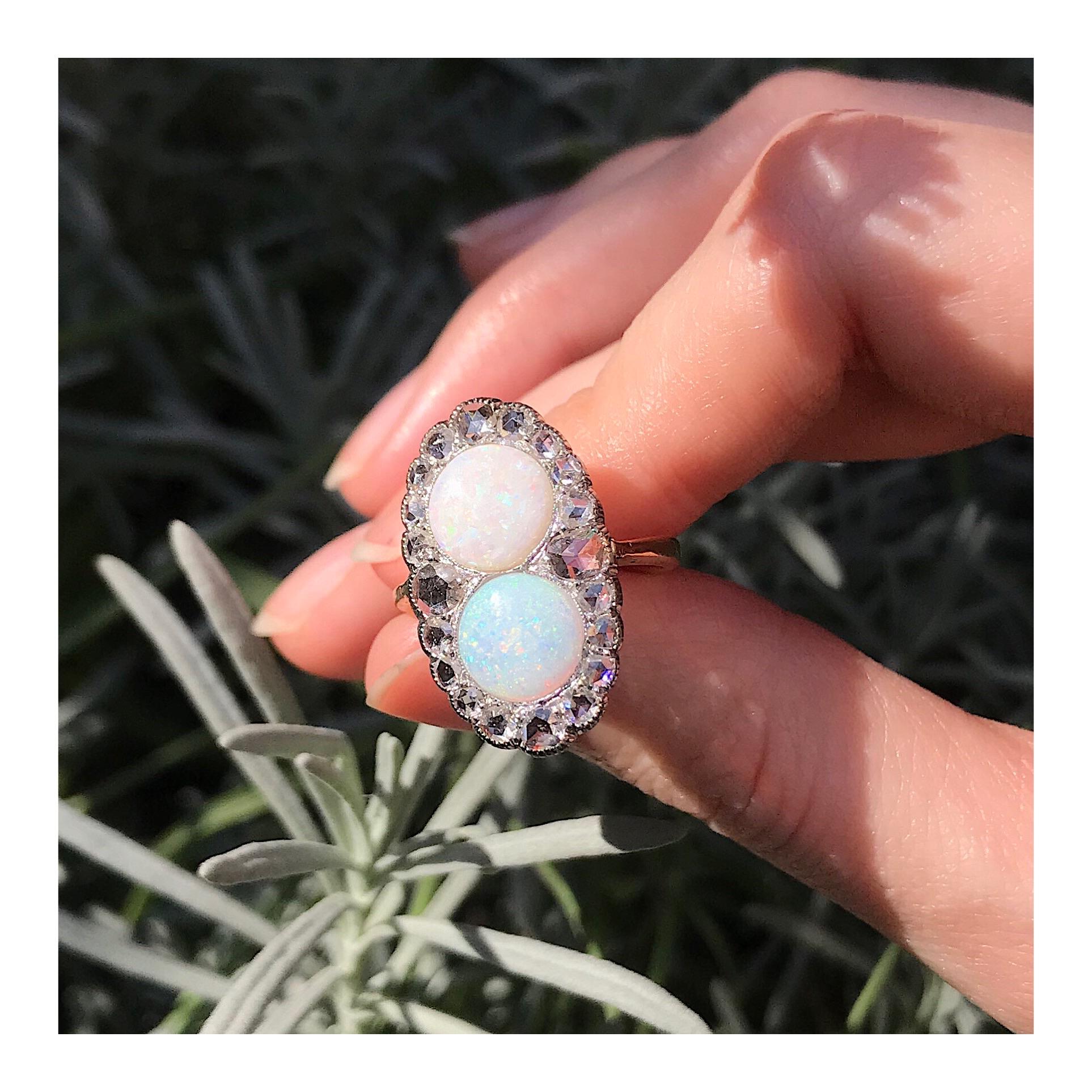 In this Victorian cluster ring from 1890, the two central cabochon cut opals seem to just keep on duplicating. With the glistening of 20 surrounding rose cut diamonds set in platinum, this whimsical jewel from 1890 could be your personal wishing