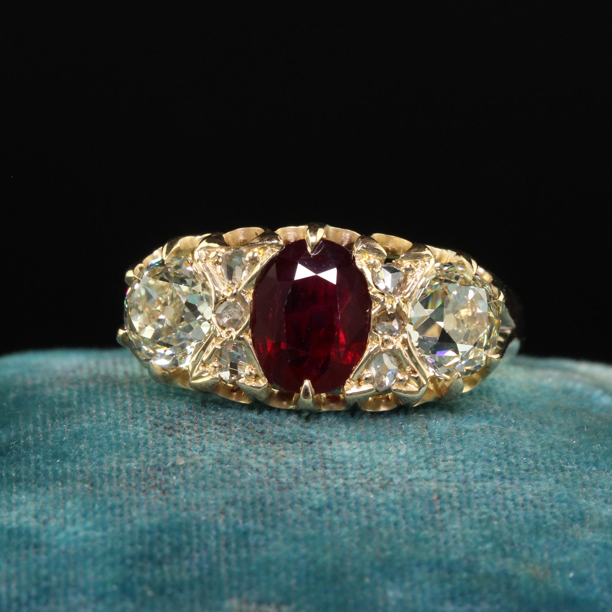 Beautiful Antique Victorian English 18K Gold Burma Ruby Diamond Three Stone Ring - GIA . This gorgeous antique Victorian English ruby and diamond ring is crafted in 18k yellow gold. The ring features a natural Burmese ruby that is unheated in the