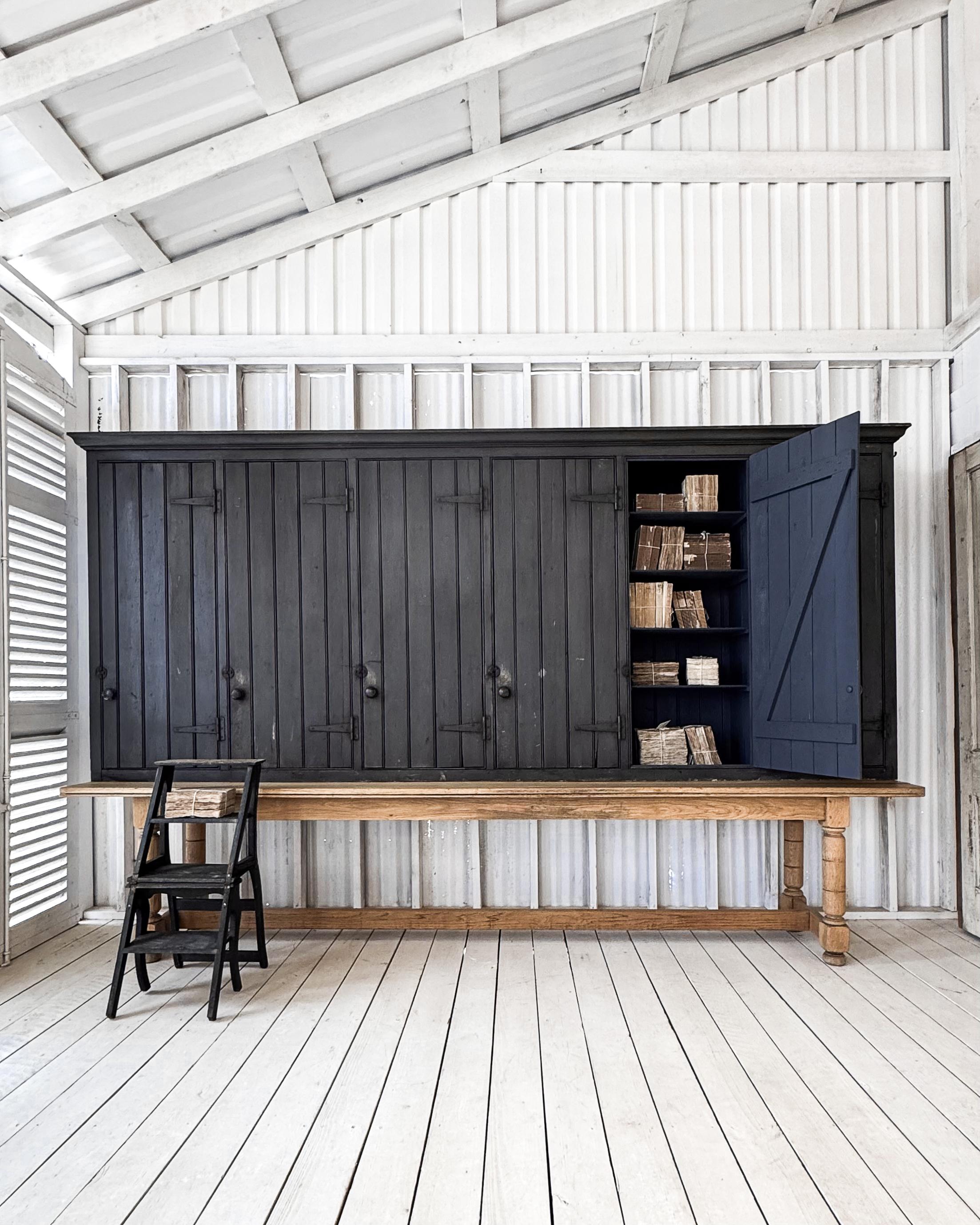 A set of antique English lockers from the 19th century, once used at a gentlemen’s club, offering a remarkable blend of history and functionality. This handsome piece features six doors with beadboard paneling, complemented by iron strap hinges and