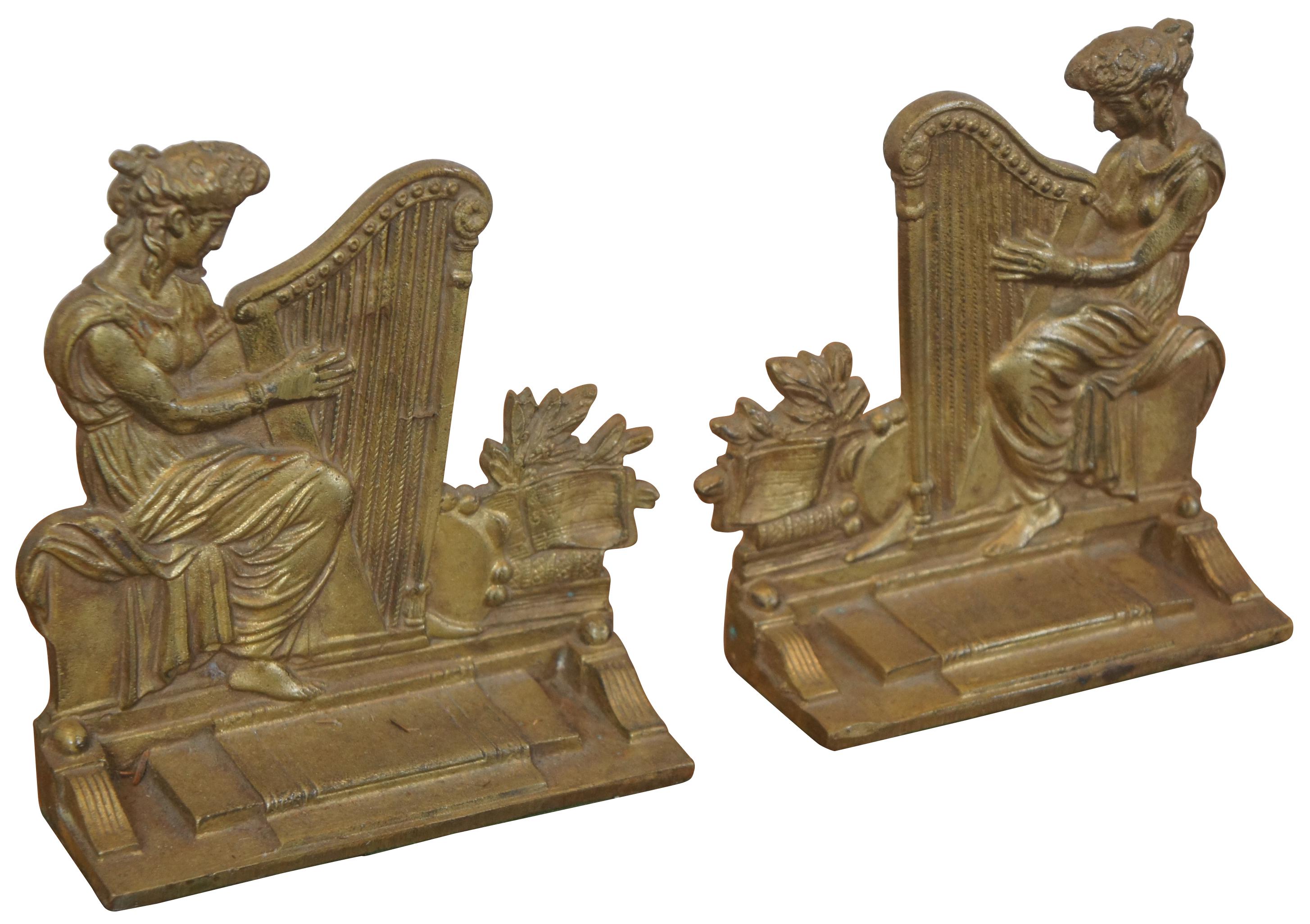 Two antique Victorian Neoclassical bronze bookends featuring a left and right facing pair of Greek or Grecian woman playing a harp (harpists). Marked England. Measure: 7