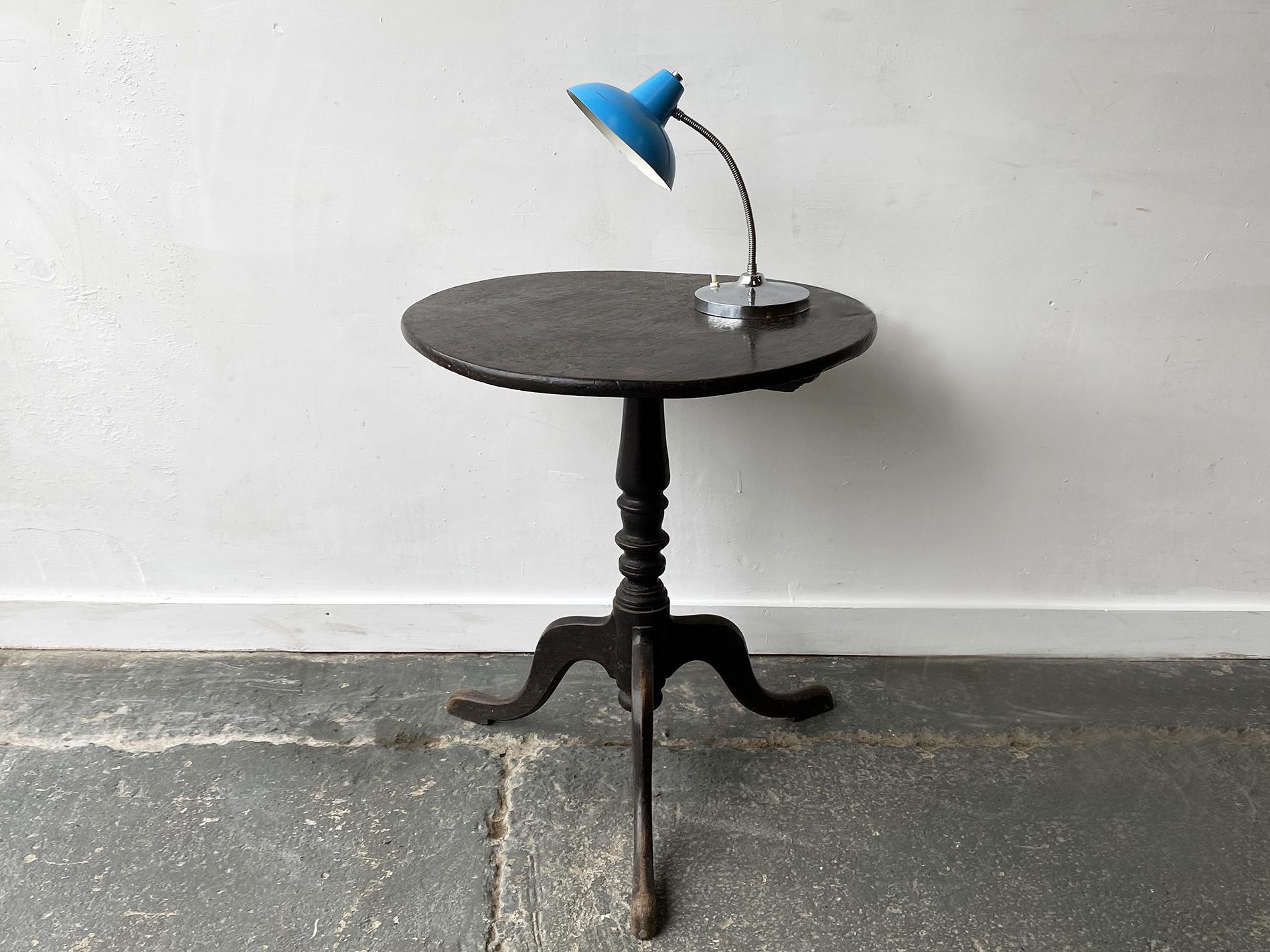 Circular tilting top 19th century side table. A vase turned pillar and three down swept legs terminating in a grip form base. Very dark in colour, with beautiful aged patina. The tilt top makes the table easy to store when not in use.

Size