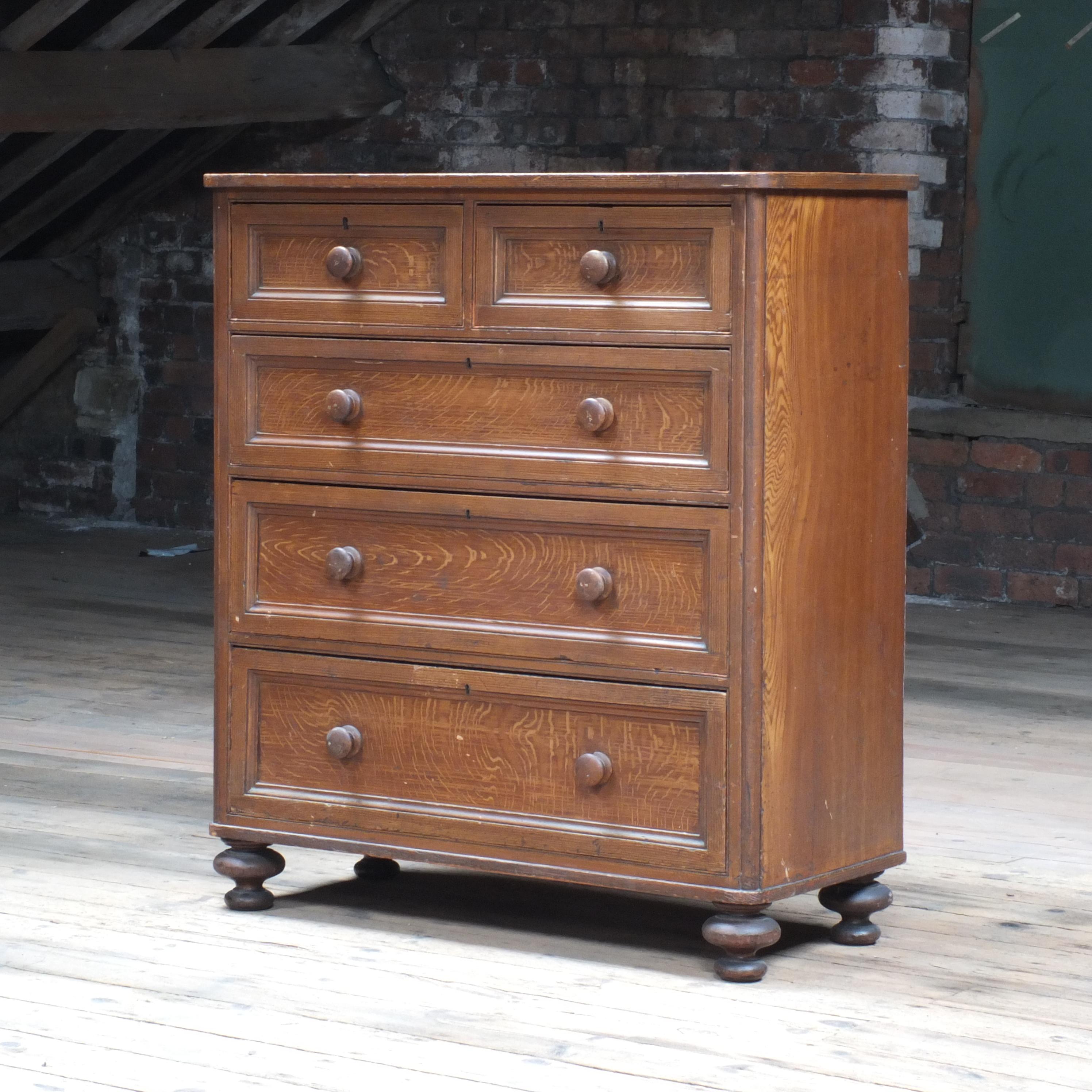 A huge Victorian chest of drawers decorated in a faux oak grained finish. In excellent condition throughout. 2 small drawers over 3 graduated and standing on the nicest turned feet. The back has been painted at some point in its life.
 