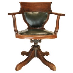 Silla de escritorio giratoria antigua victoriana inglesa de cuero verde y roble