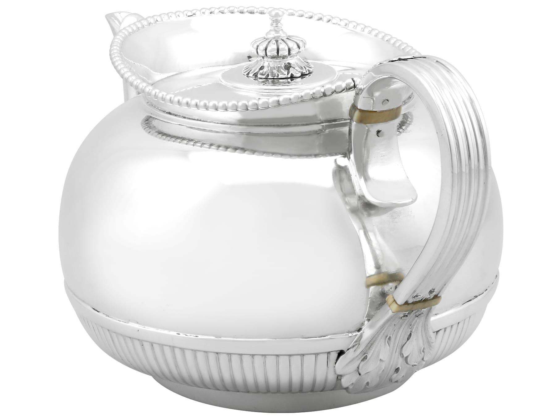 An exceptional, fine and impressive antique Victorian English sterling silver bachelor teapot; an addition to our silver teaware collection.

This exceptional antique Victorian teapot, in sterling standard silver, has a circular rounded form.

The