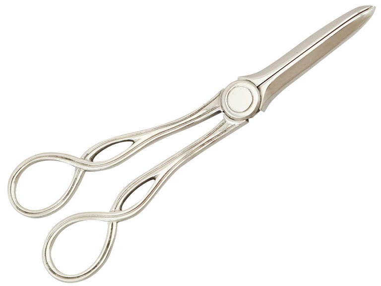 An exceptional, fine and impressive pair of antique Victorian English sterling silver grape shears, boxed, an addition to our silver flatware collection.

These exceptional antique Victorian sterling silver grape shears have a hinged scissor